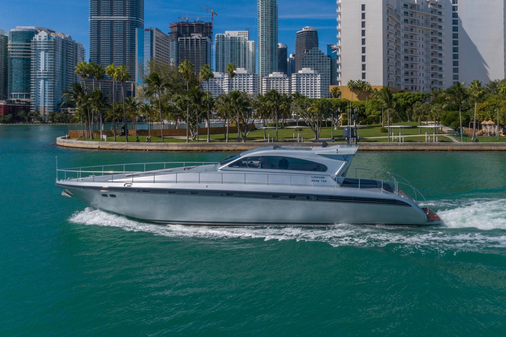 2007 Leopard Express Motor Yacht cruising near city skyline and palm trees.