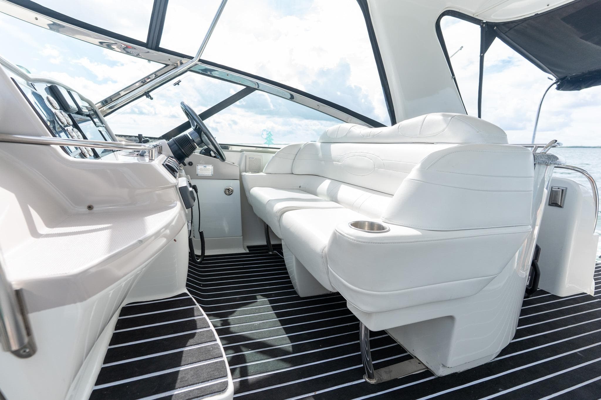 Interior of 2005 Formula 48 Yacht with white seating and modern dashboard.