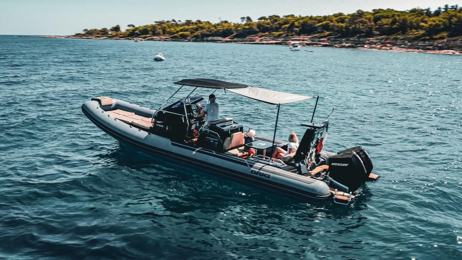 2018 Brig Eagle 10 boat on calm water near coastline.
