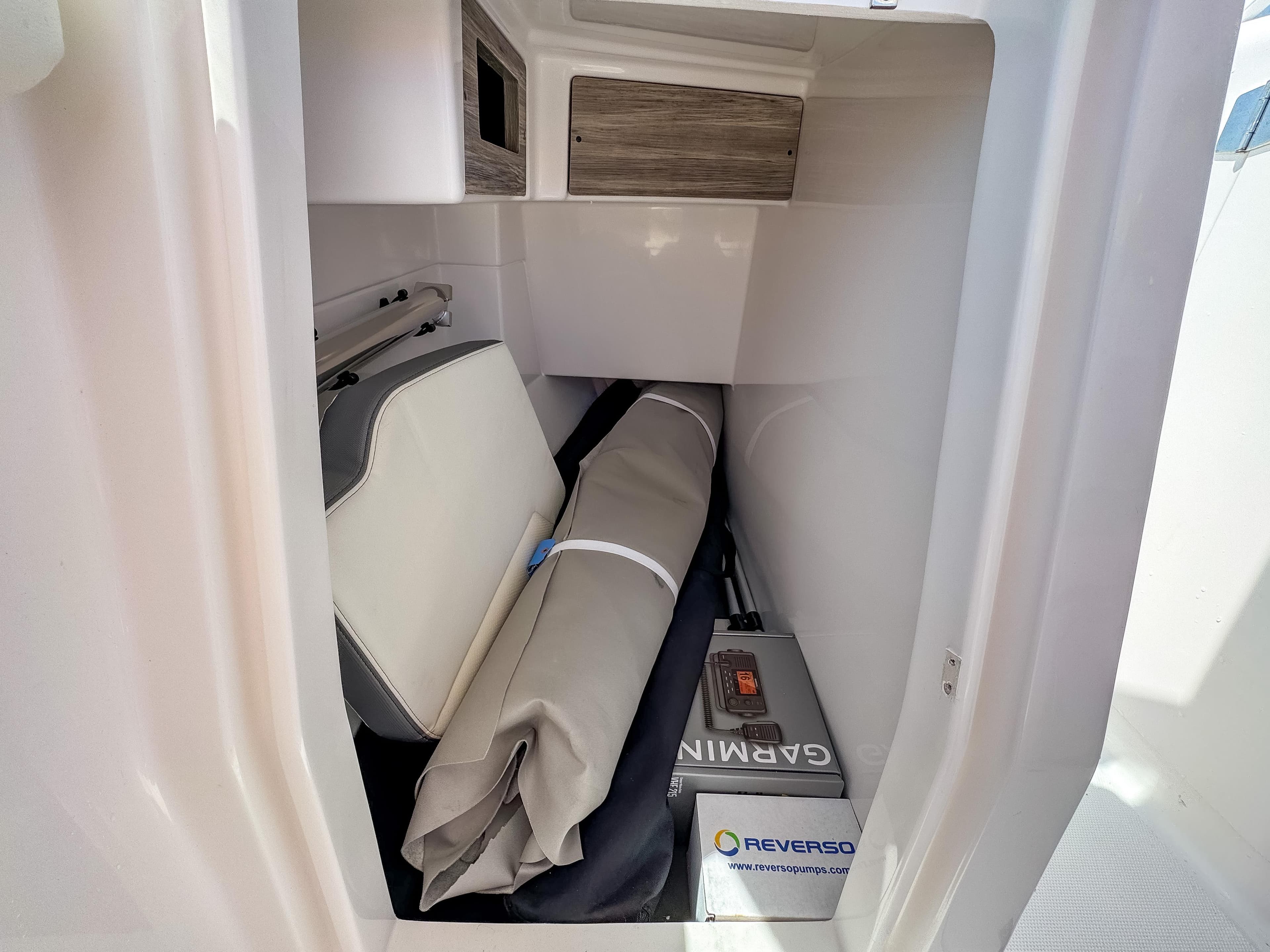2025 Edgewater 262 CX storage compartment with Garmin and Reverso equipment.