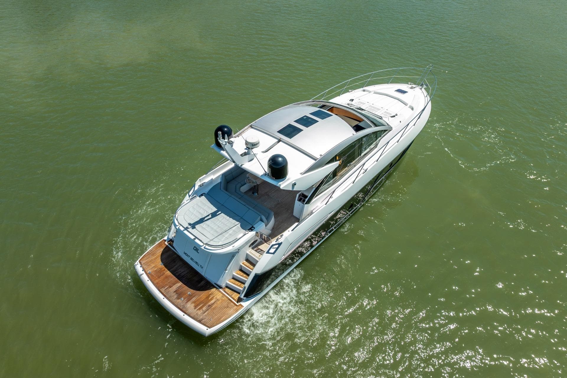 2018 Sunseeker Predator 57 yacht cruising on calm green waters.