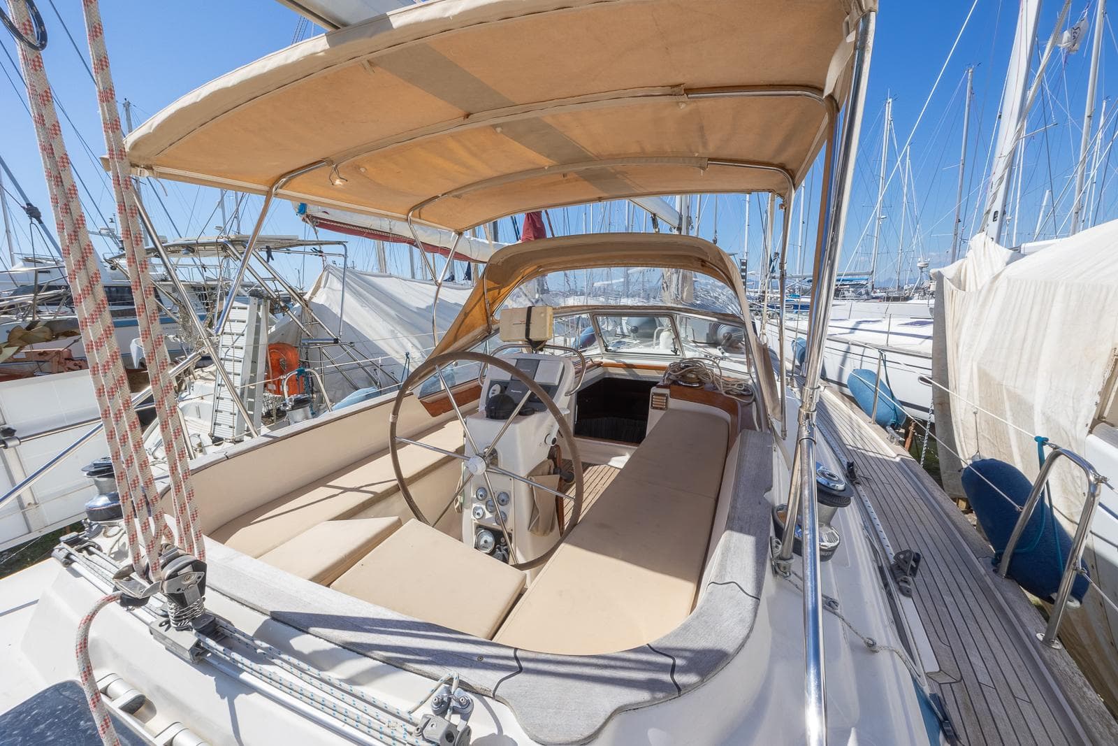 Bavaria 42 Ocean sailboat, 1999 model, featuring spacious cockpit and helm, docked at marina.