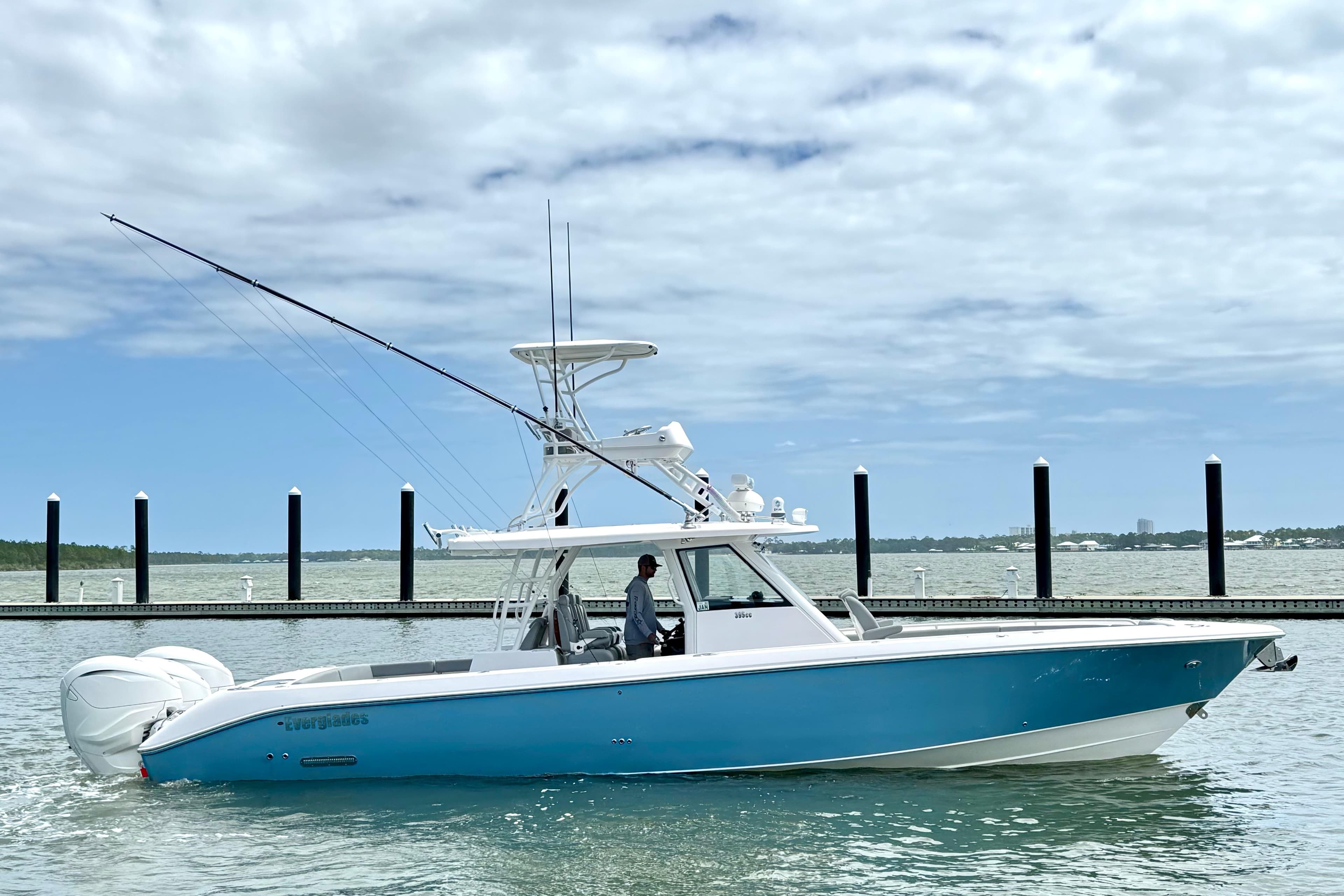 2023 Everglades 395 Center Console boat on water, clear sky background.