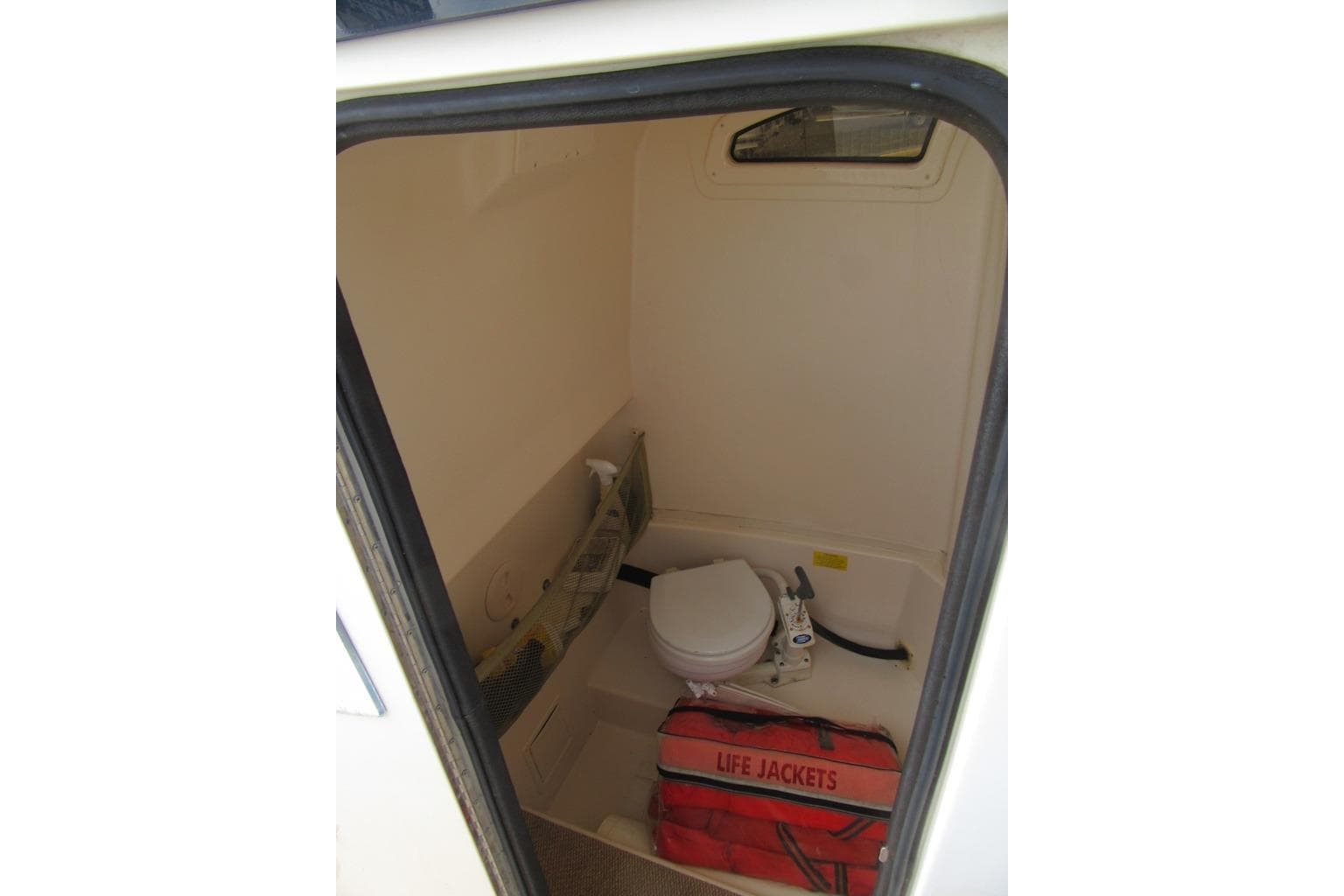 2012 Grady-White Canyon 271 boat interior with toilet and life jackets.