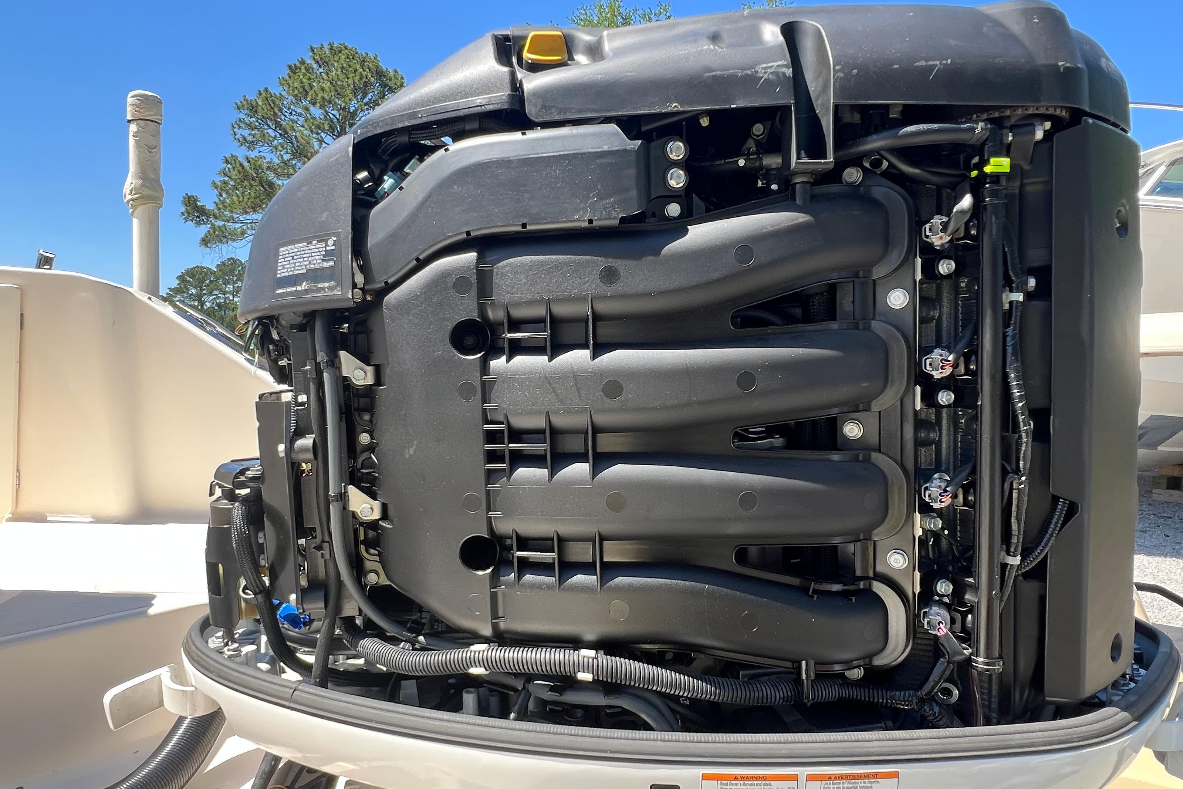 Close-up of a 2011 Pursuit DC 265 Dual Console boat engine, showcasing intricate details.