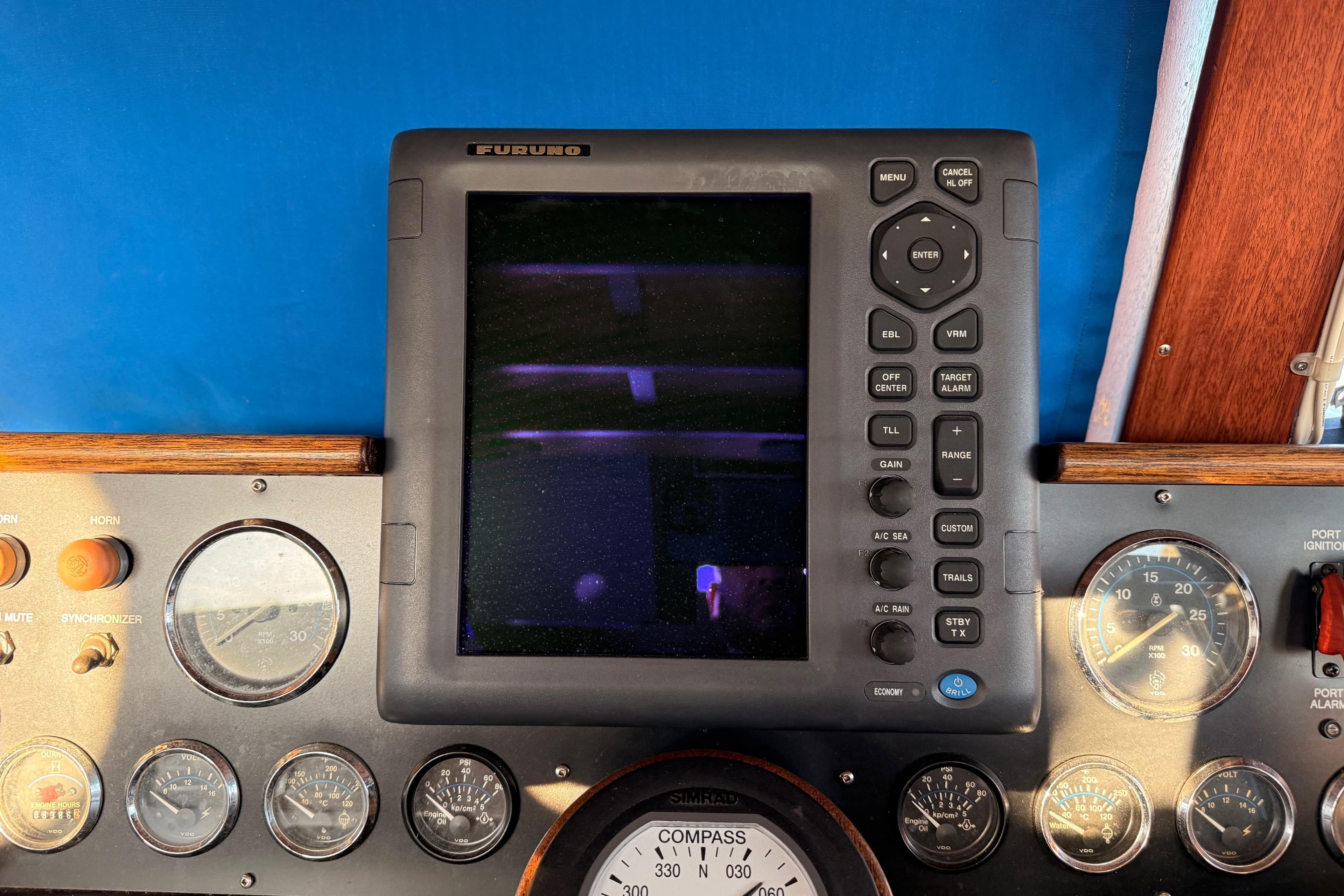 Control panel of a 1965 Custom Trawler with navigation instruments and gauges.