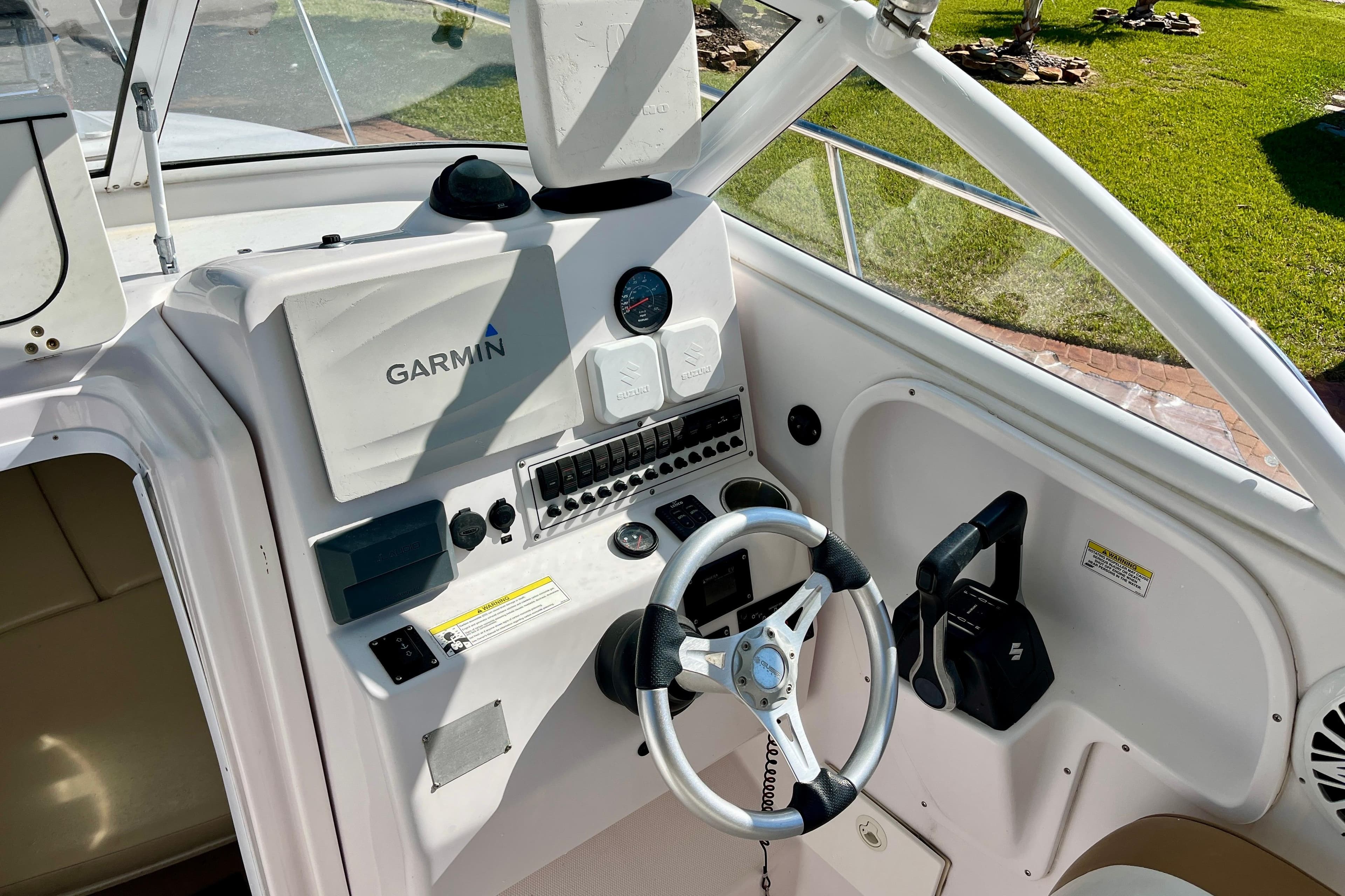 Cockpit of 2018 Pro-Line 26 Express boat with Garmin navigation system and steering wheel.