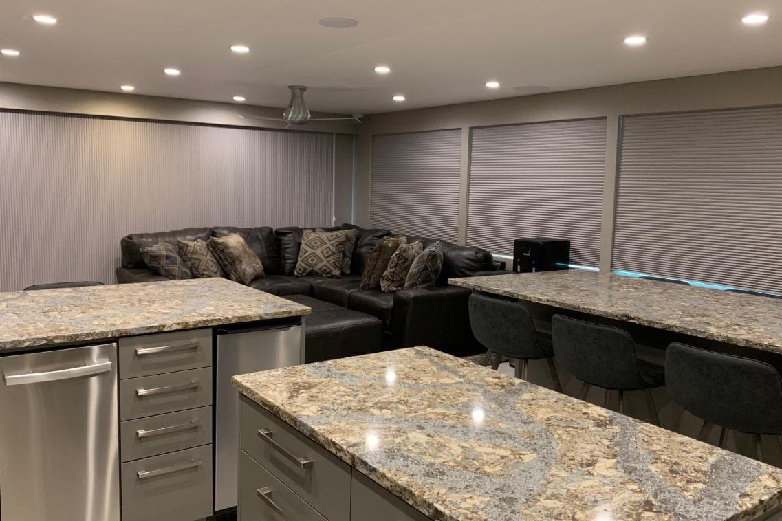 Modern kitchen with granite countertops, stainless steel appliances, and cozy seating area.