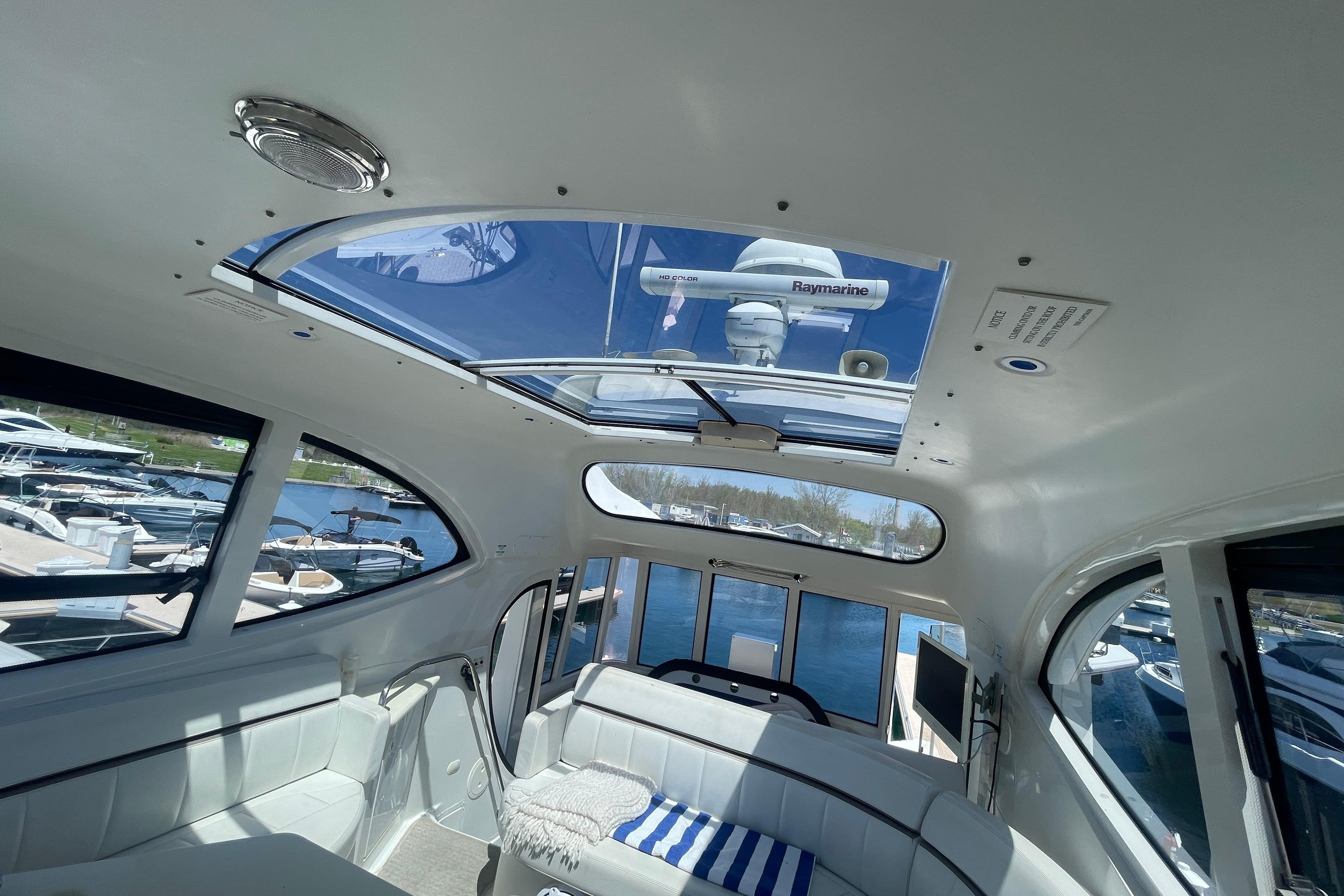 Interior view of 2000 Carver 506 Motor Yacht with skylight and marina backdrop.