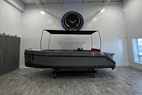 2023 Vision Marine Technologies Volt 180 boat displayed in a modern showroom.