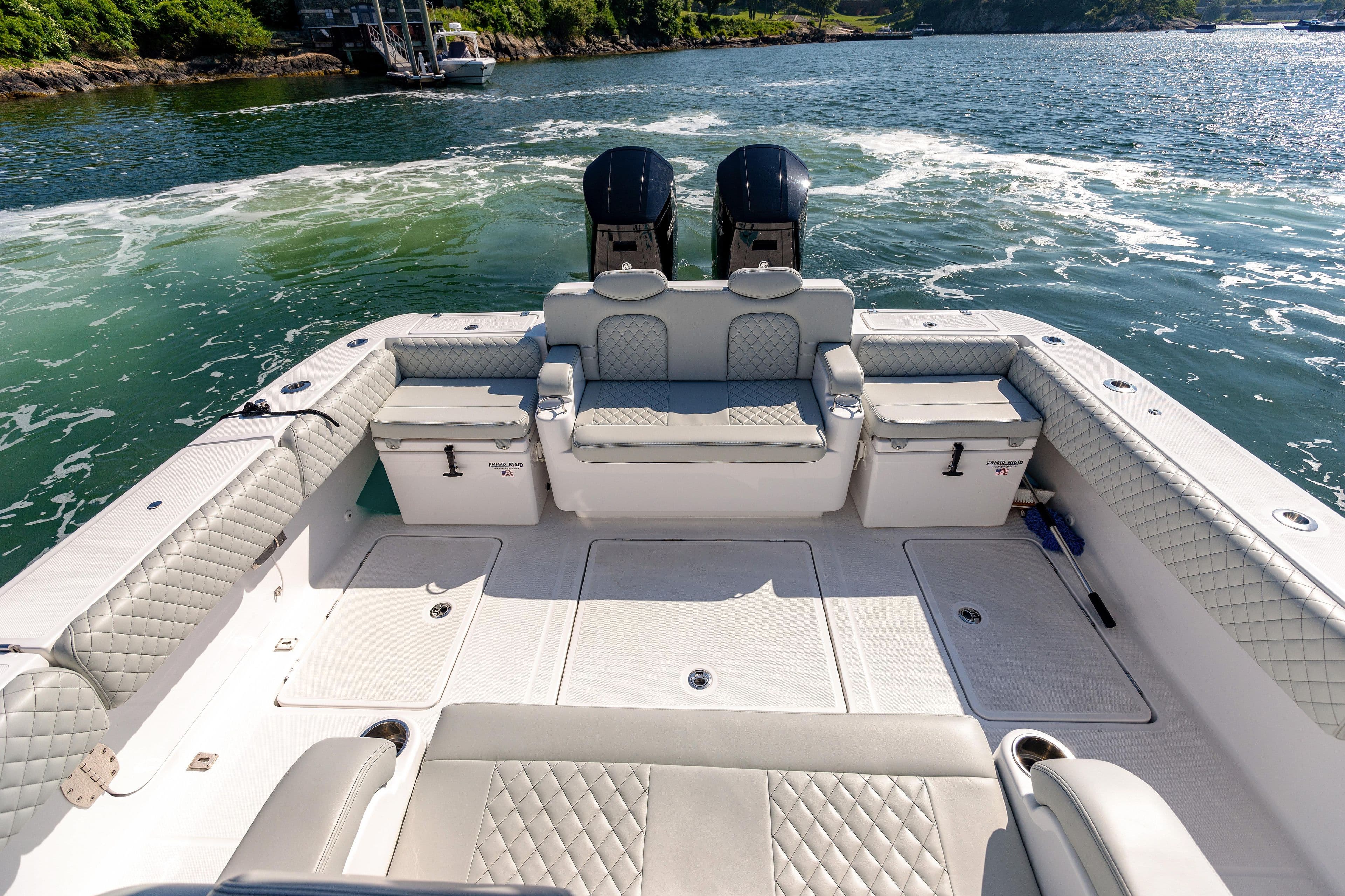2024 HCB 39 Speciale boat with luxurious seating and twin outboard engines on the water.