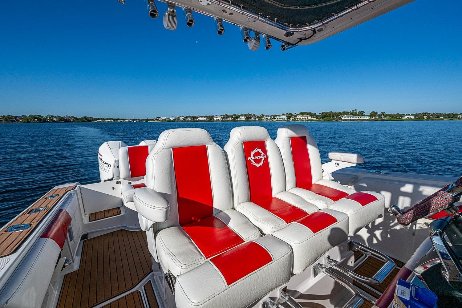 2009 Fountain 38 Center Console boat with red and white seating on a sunny day.