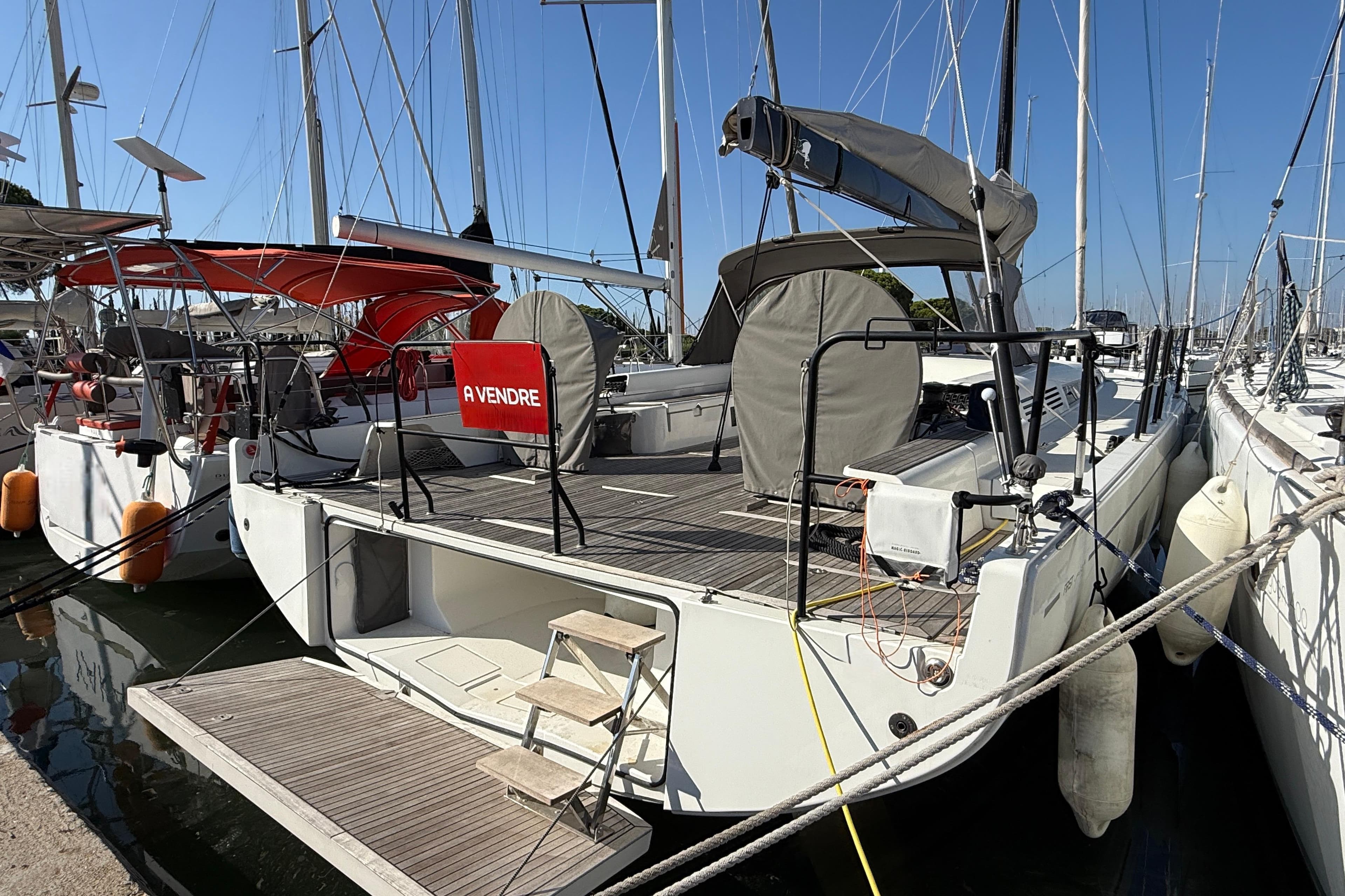 2020 Beneteau First 53 yacht docked, for sale sign visible, marina setting.