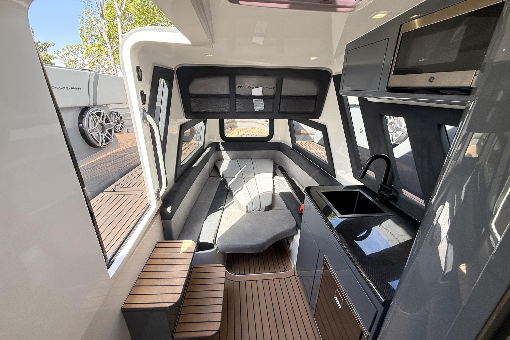 Luxurious interior of 2023 Midnight Express 43 Solstice yacht with modern kitchen and seating area.