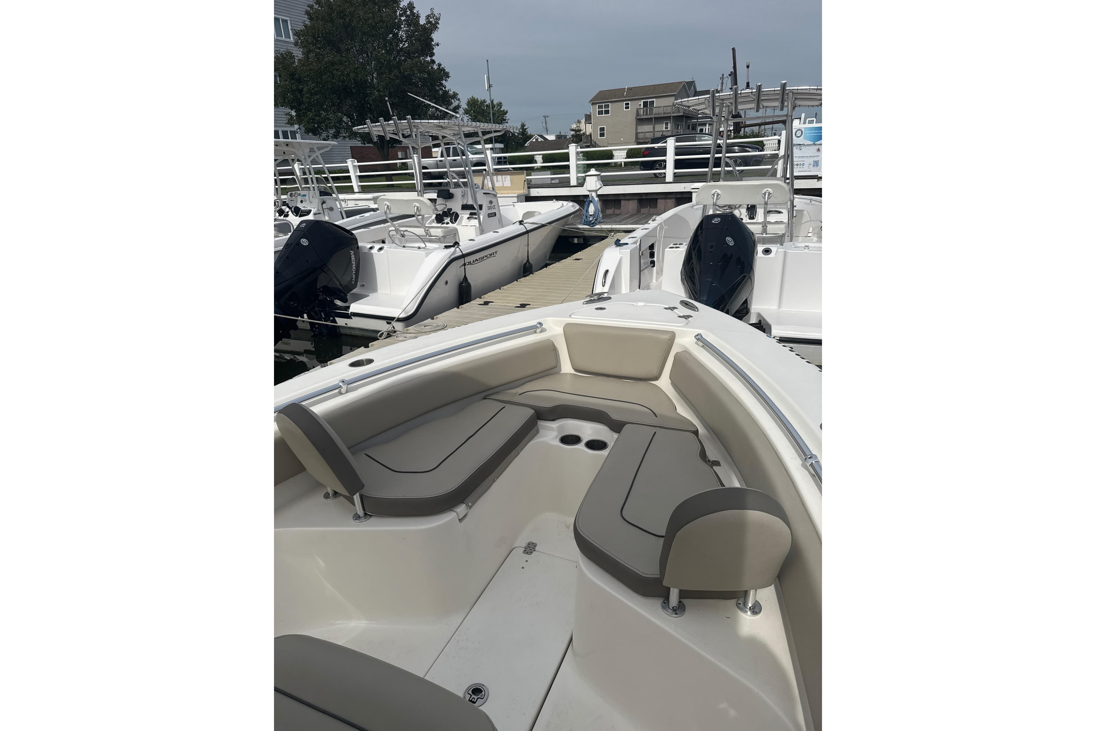 2024 Key West 239 FS boat docked, featuring spacious seating and modern design.