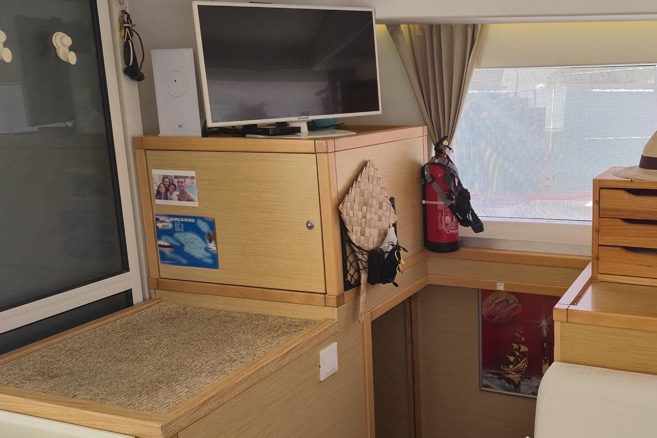 Interior of a 2017 Lagoon 400 S2 yacht with TV, fire extinguisher, and decor.