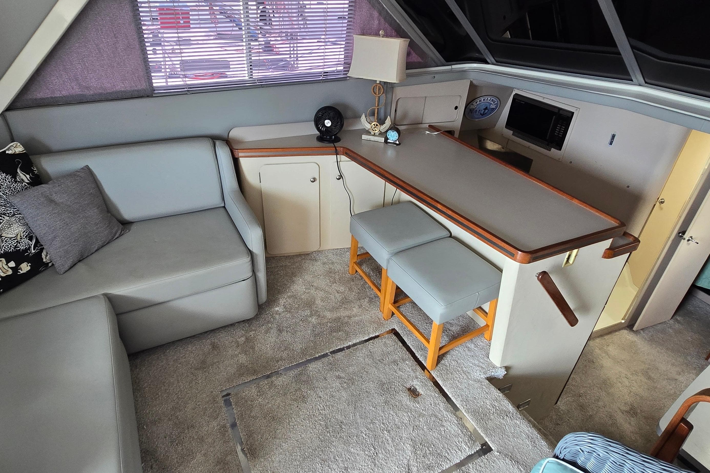 Interior of 1987 Trojan 10.8 Meter Sedan with seating, table, and decor.