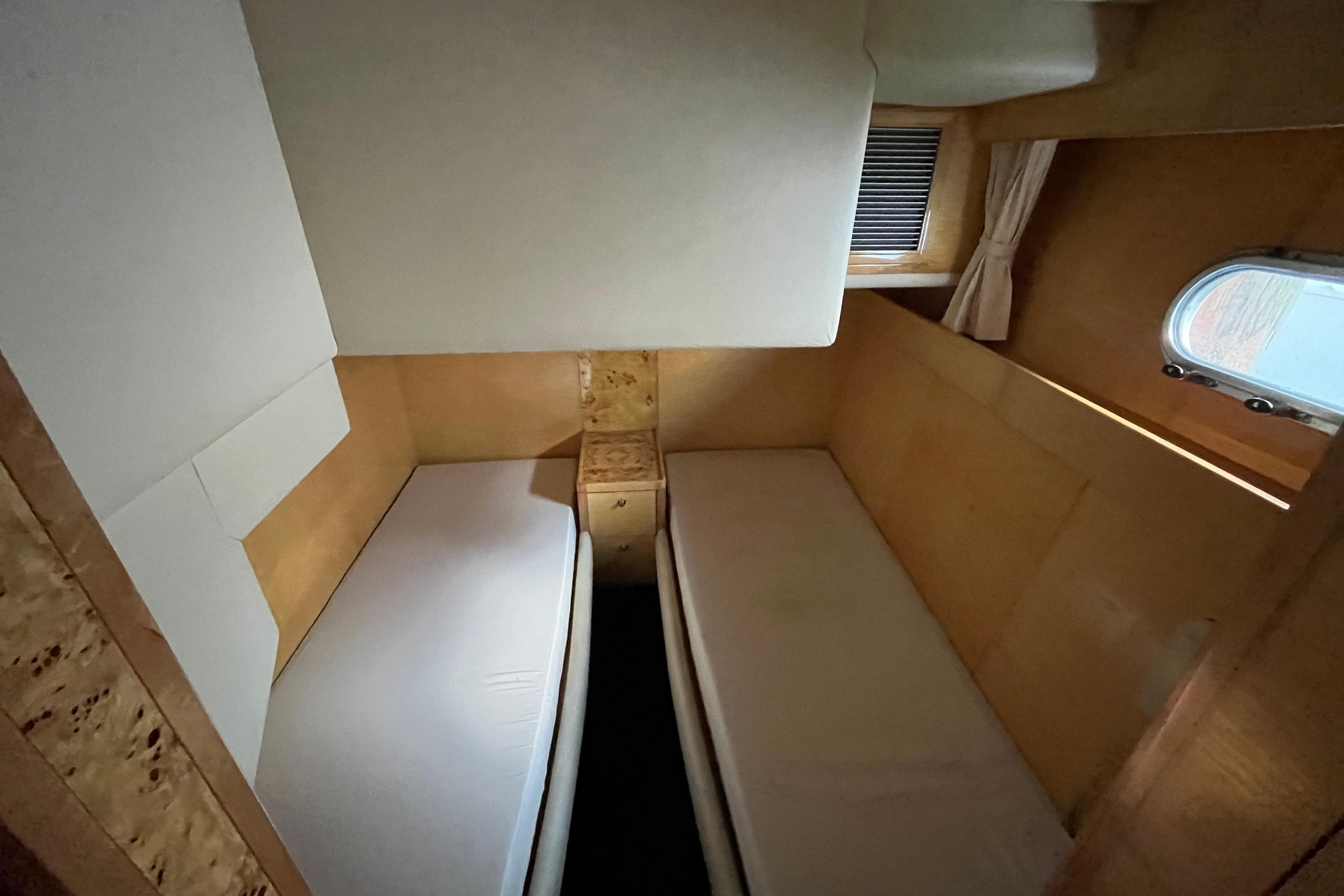 Interior of 2001 Jefferson International 5300 with twin beds and wooden paneling.