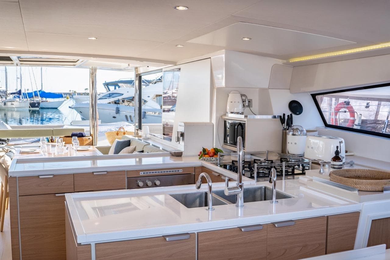 Luxurious 2023 Bali 5.4 yacht kitchen with modern appliances and marina view.