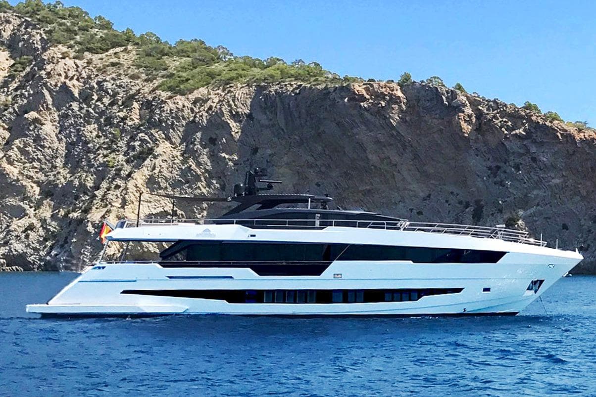 2025 Astondoa Century 100 yacht cruising near rocky coastline.