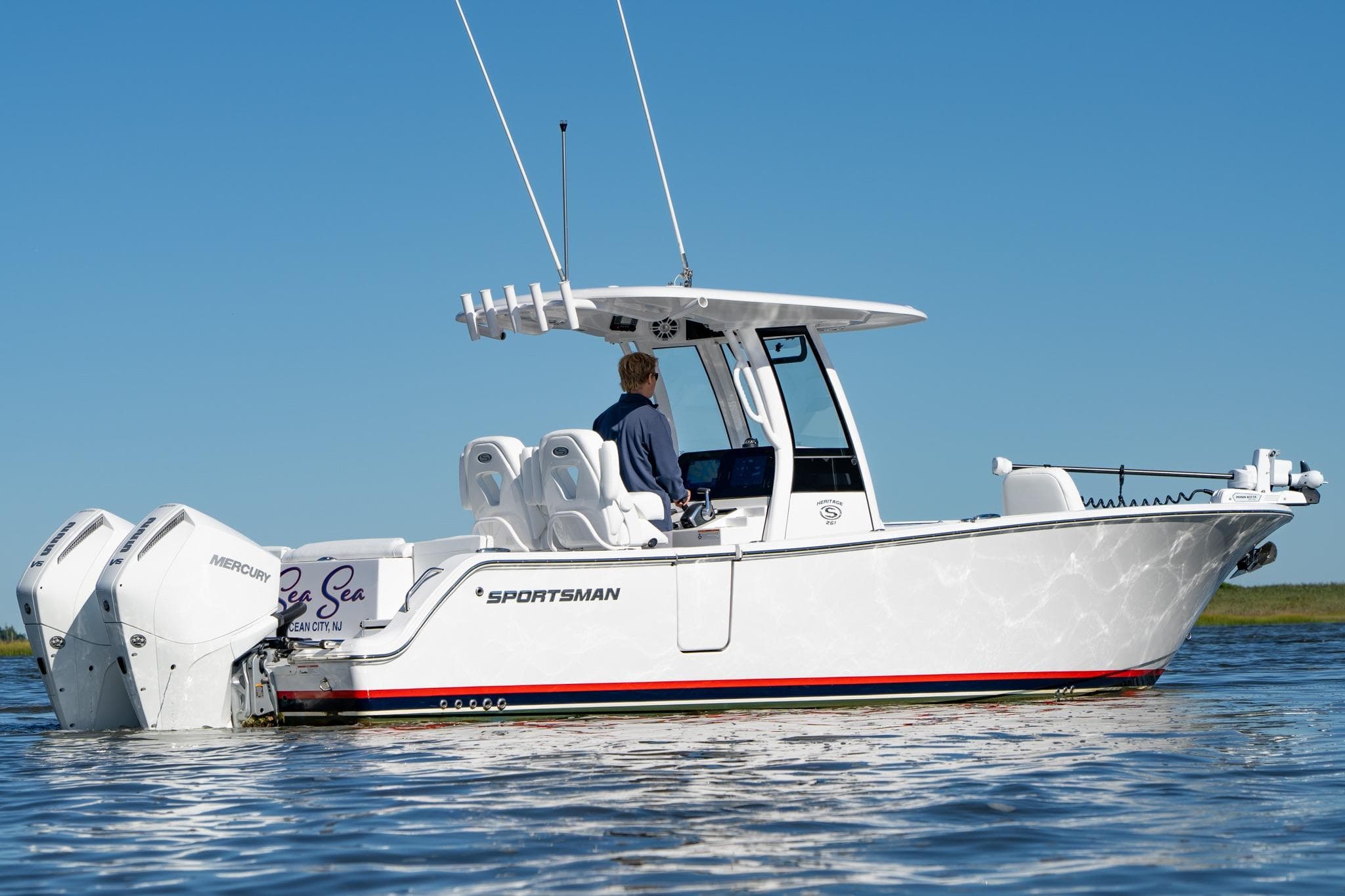 2024 Sportsman Heritage 261 Center Console boat on water, featuring dual Mercury engines.