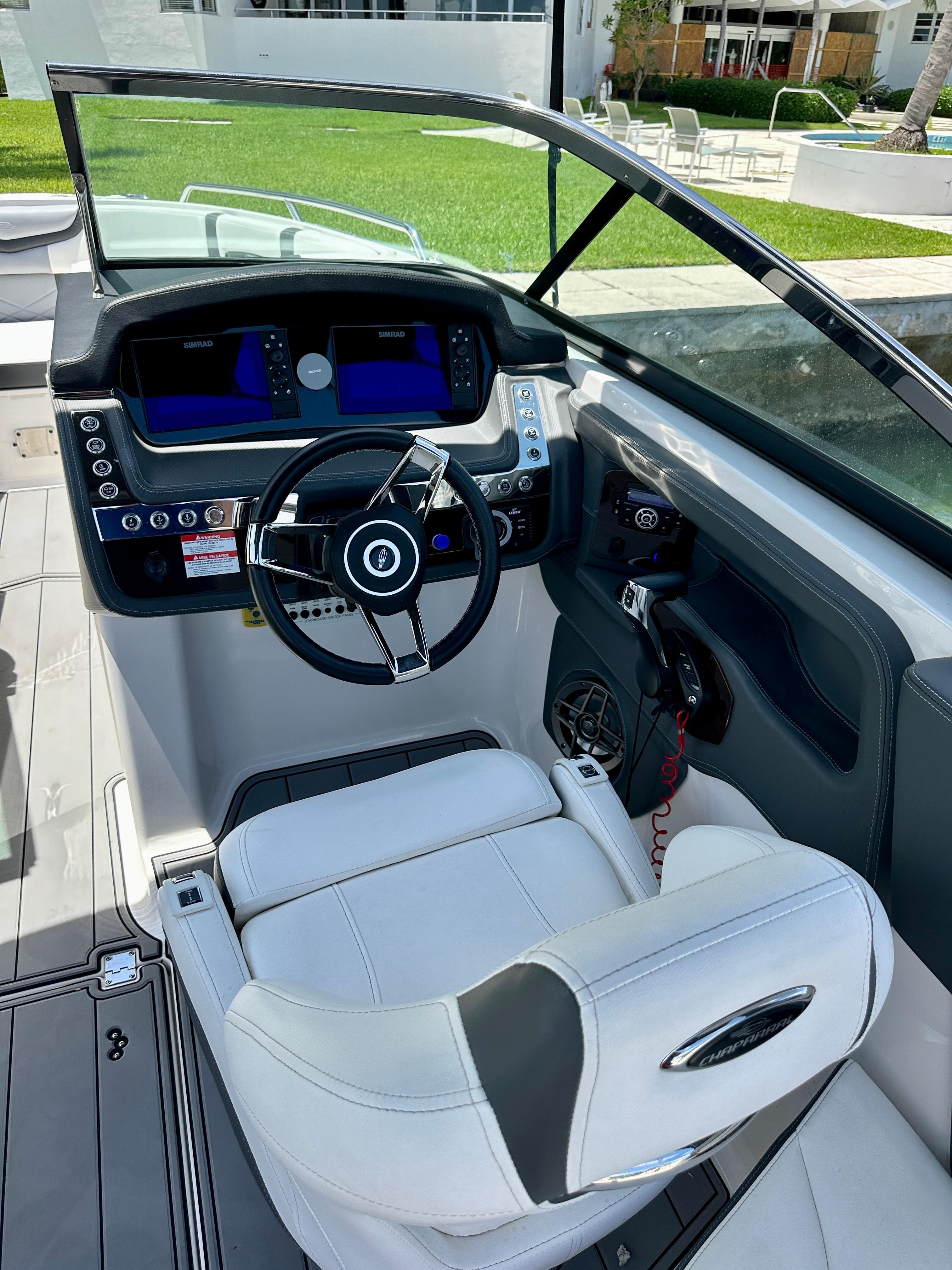2022 Chaparral 267 SSX OB boat cockpit with modern controls and comfortable seating.
