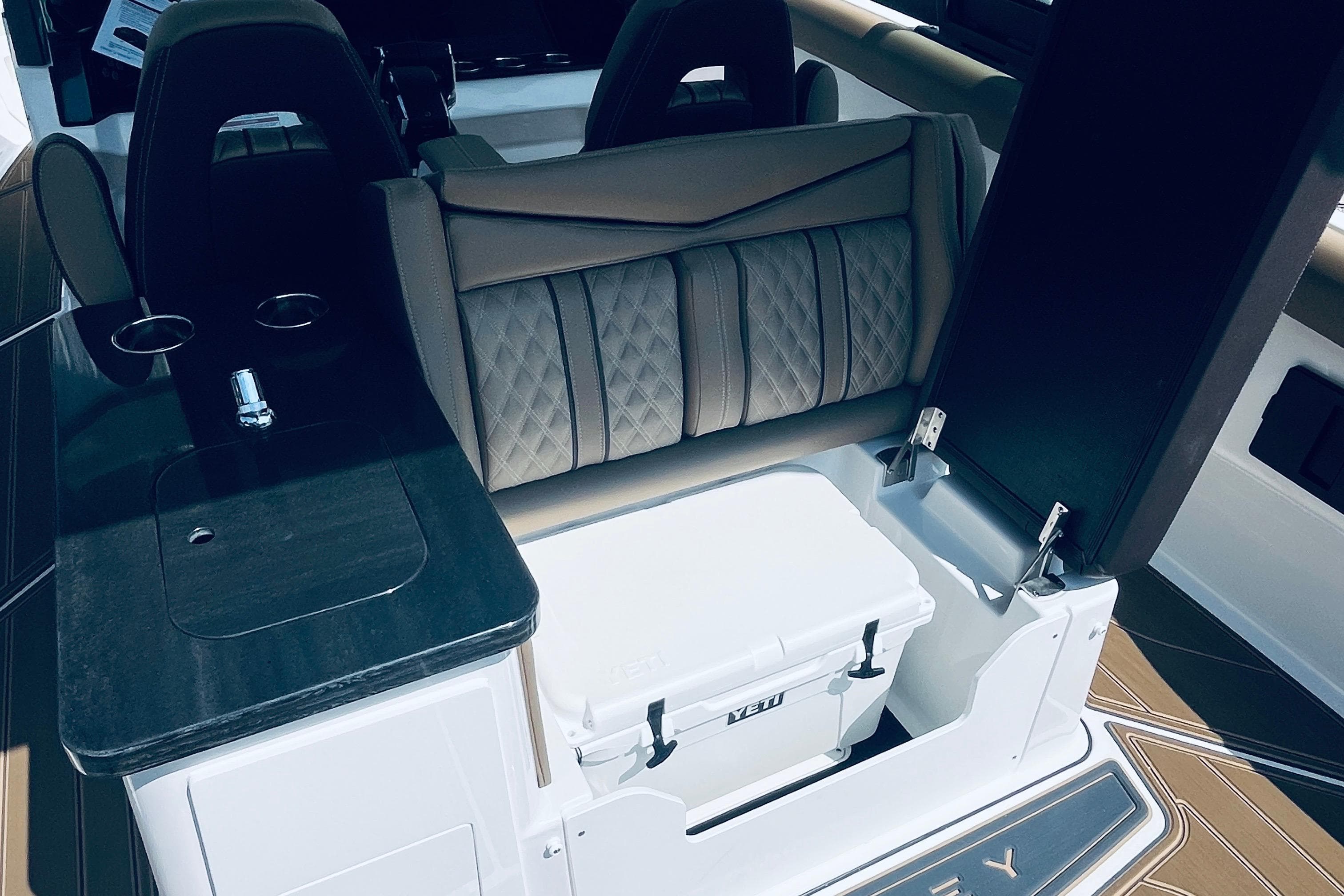 Interior of 2026 Monterey Elite 30 OB boat with seating and storage.