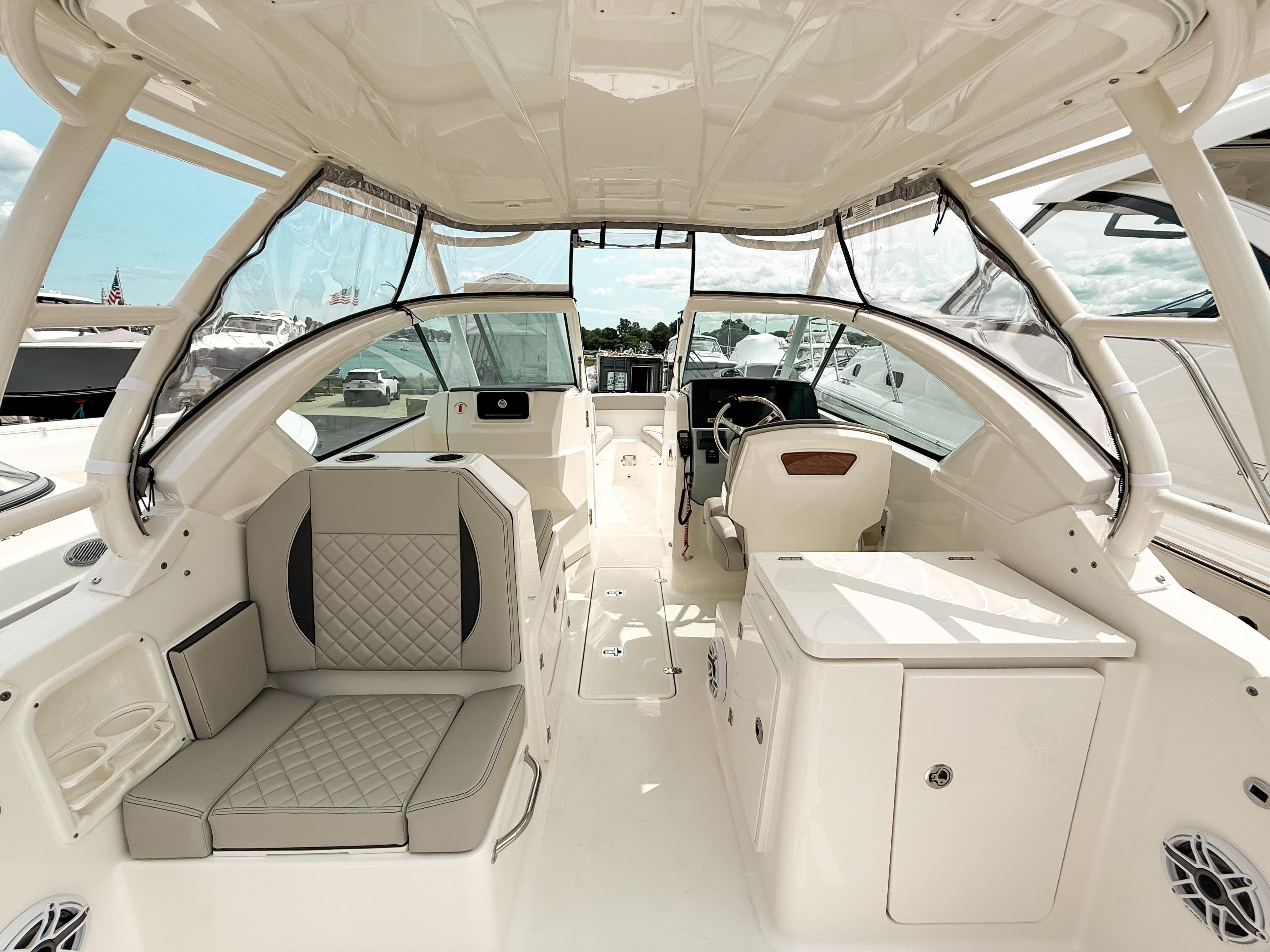2025 Pursuit DC 266 Dual Console boat interior with seating and helm, showcasing luxury design.