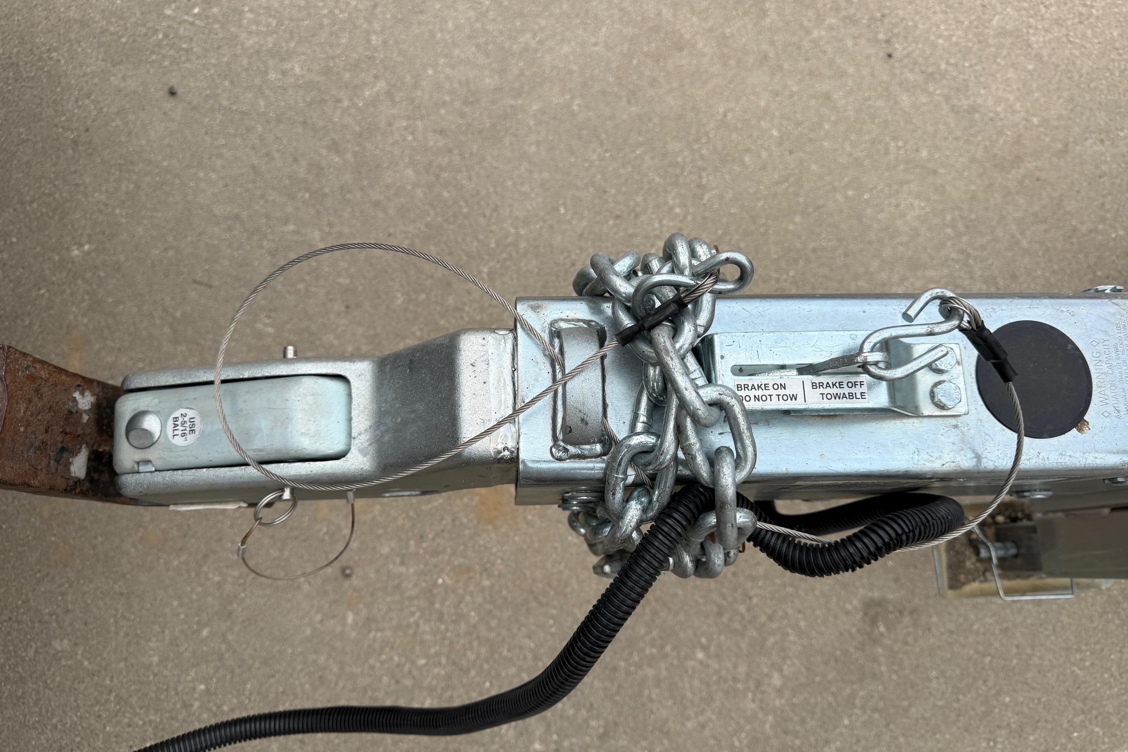 Trailer hitch with chains and brake labels for 2022 Boston Whaler 270 Dauntless.
