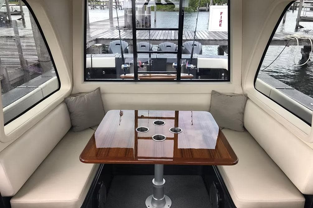 Manufacturer Provided Image: Luxurious interior of 2026 Ocean Yachts 52 CC with elegant seating and polished table.