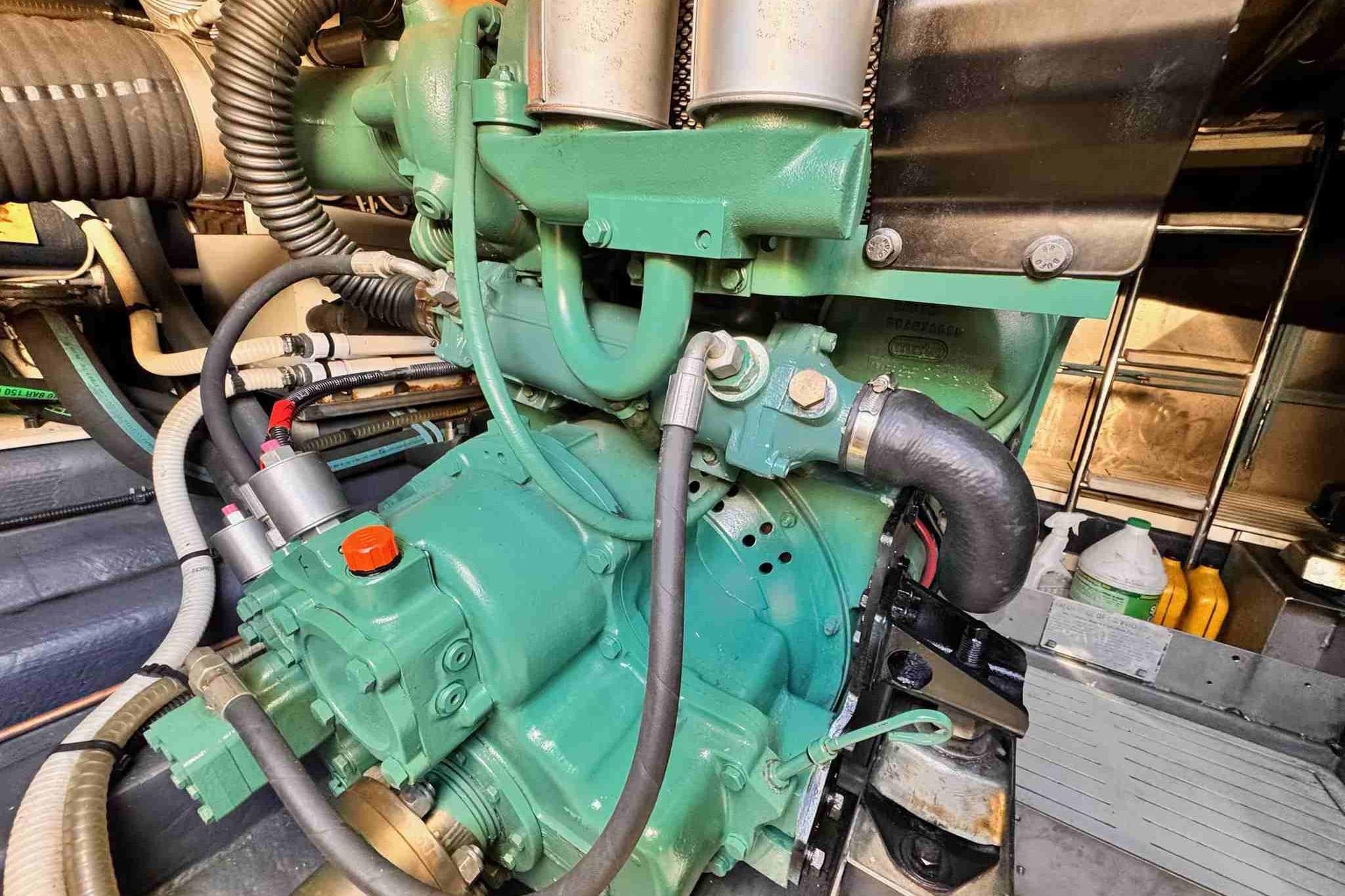 Engine compartment of 2003 Cranchi Atlantique 50 yacht, showcasing mechanical components and hoses.