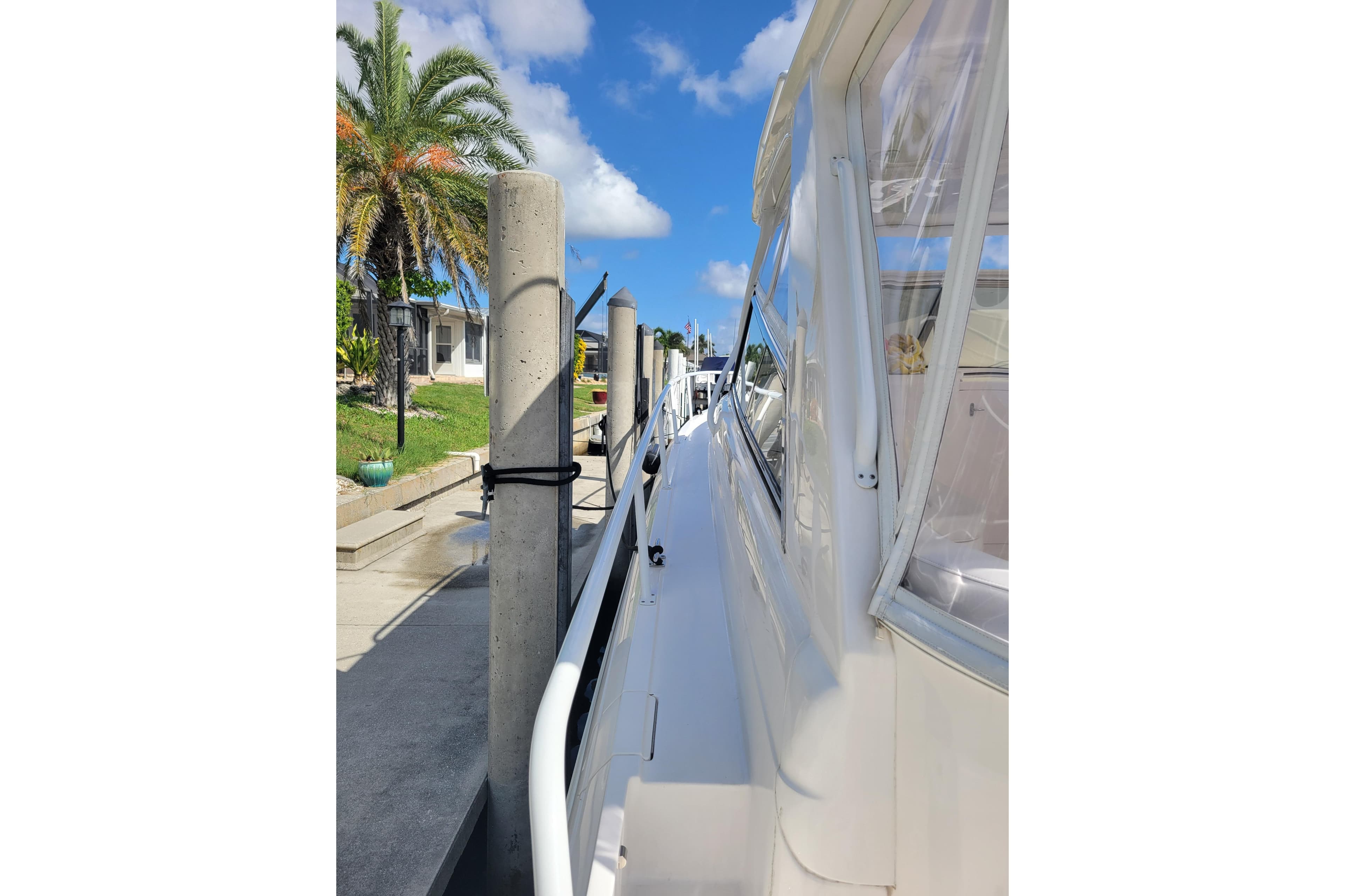 2016 Intrepid 475 Sport Yacht docked, featuring sleek design and clear skies.