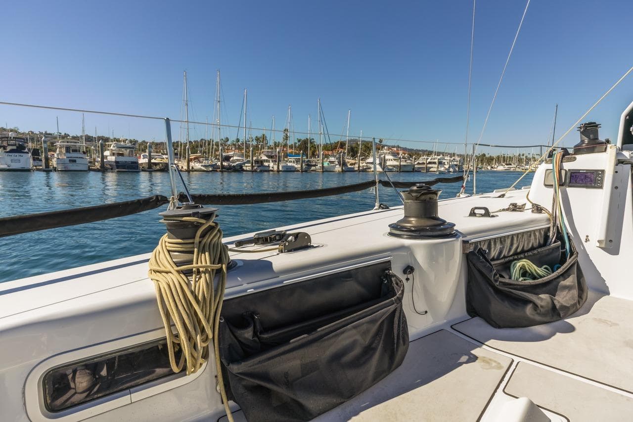 Sailboat deck view in marina, Rogers 46 model, 2007, with moored yachts in background.