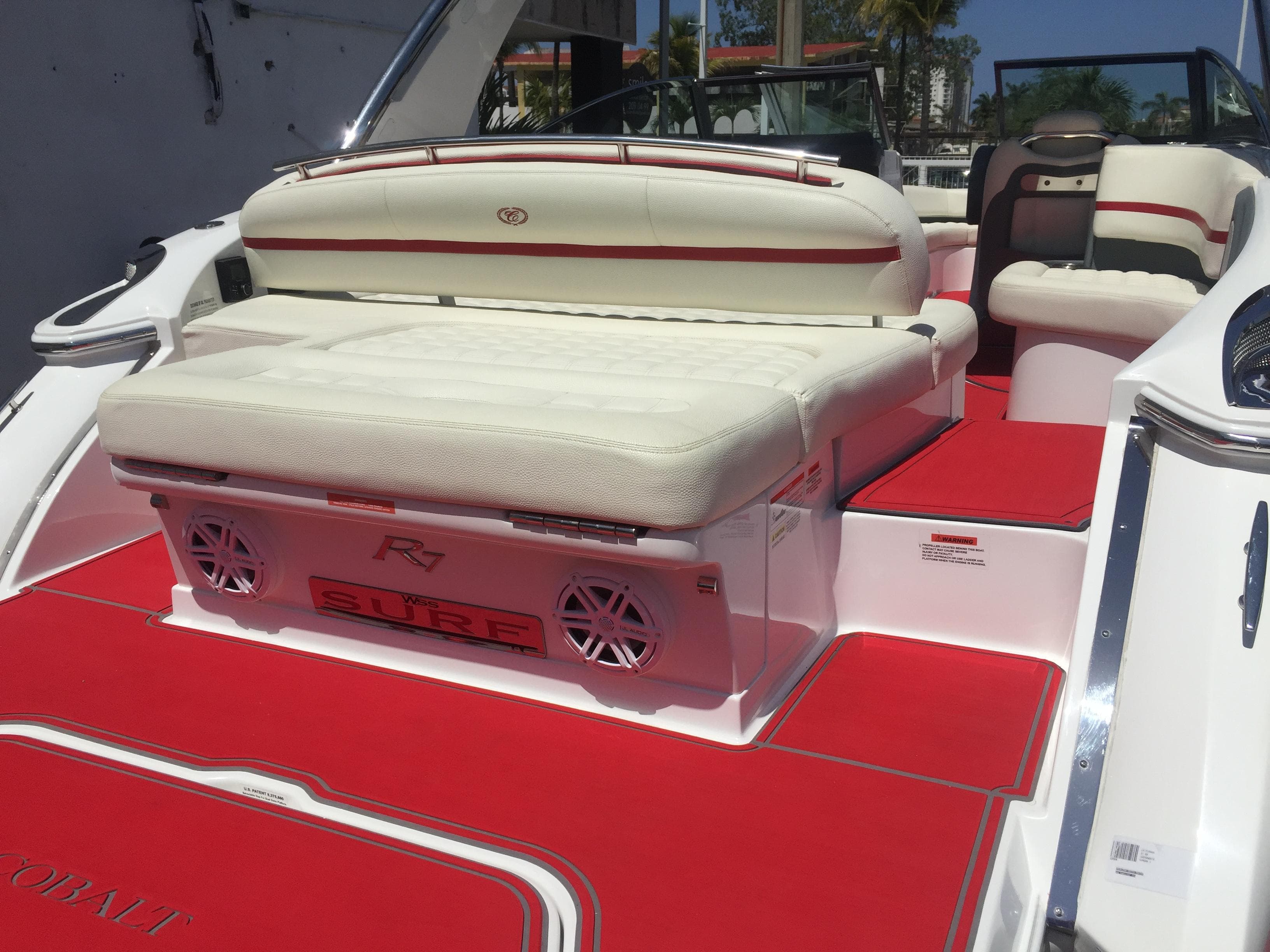 2017 Cobalt R7 WSS Surf boat with red and white interior seating.