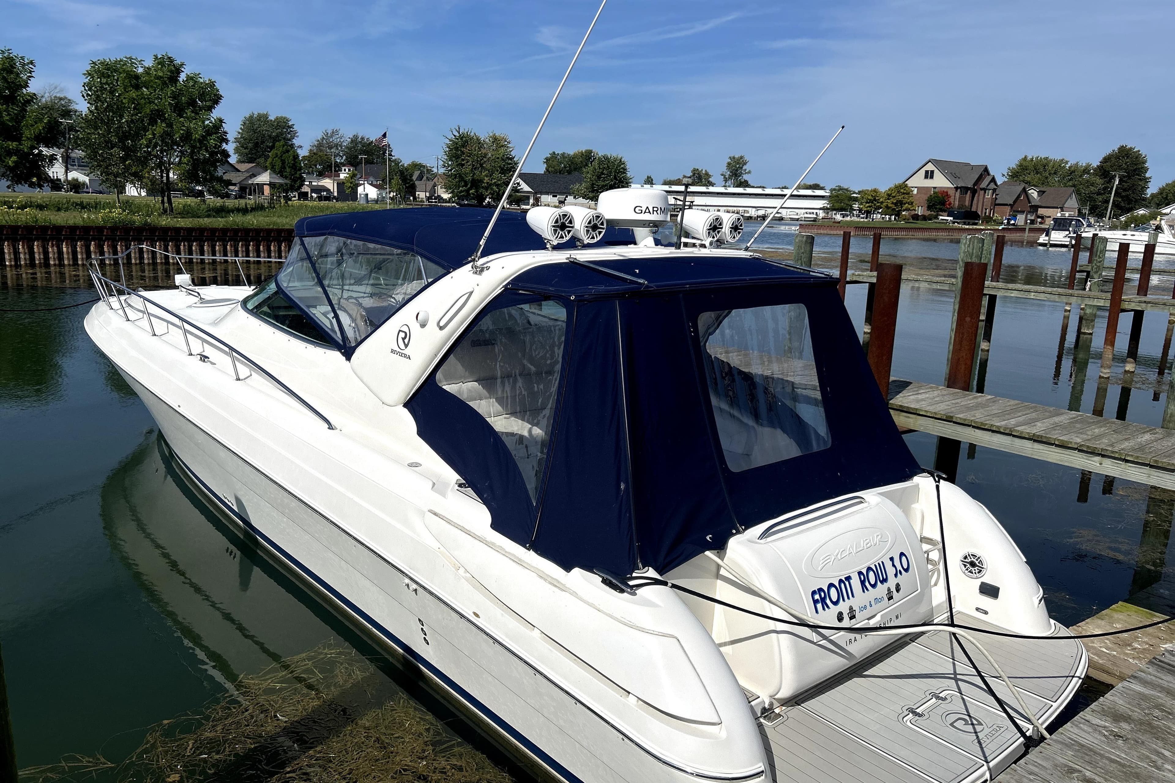 2004 Wellcraft 47 Excalibur boat docked in a serene marina setting.