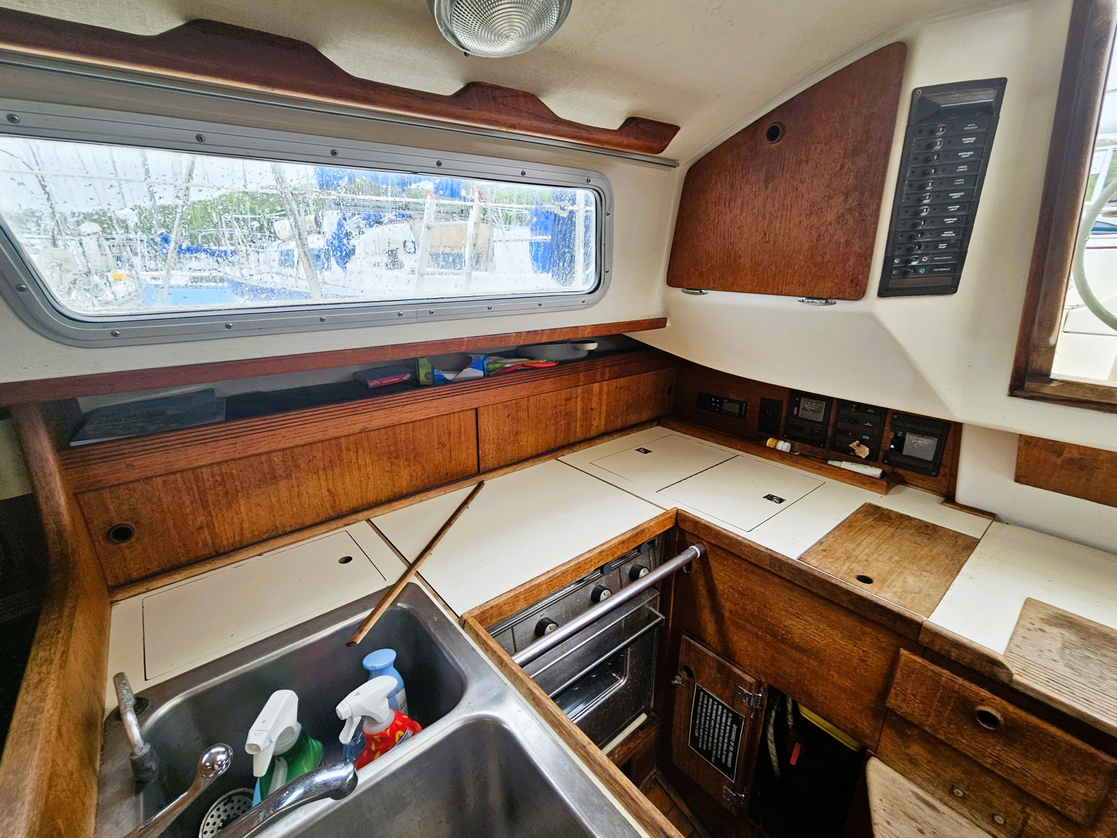 Interior of a 1985 Sabre 34 yacht with kitchen and wood paneling.
