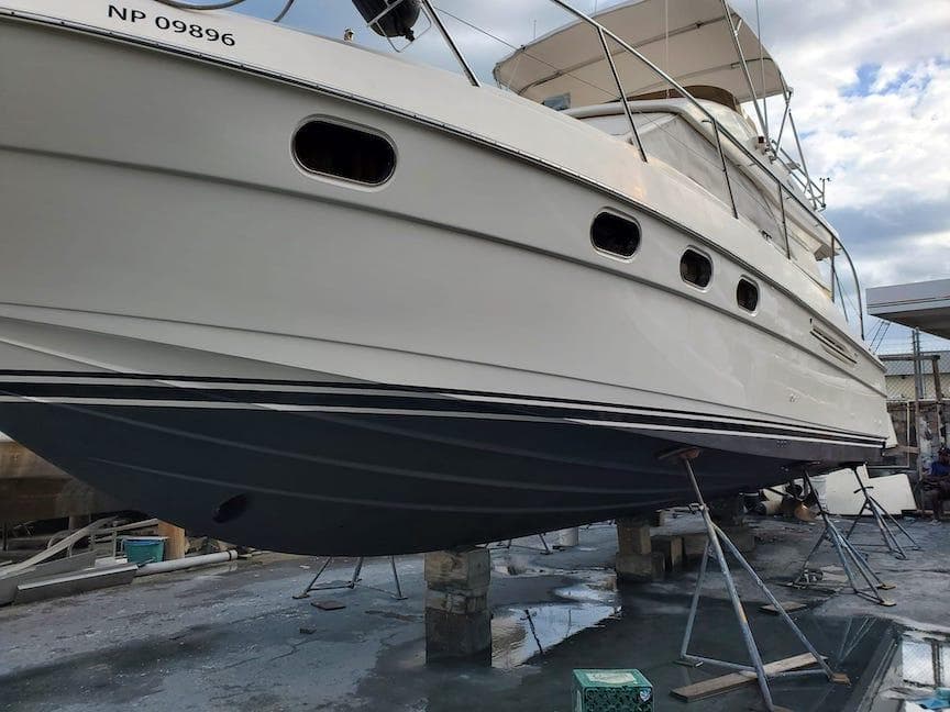 1998 Viking Sports Cruiser on dry dock, showcasing hull and design details.