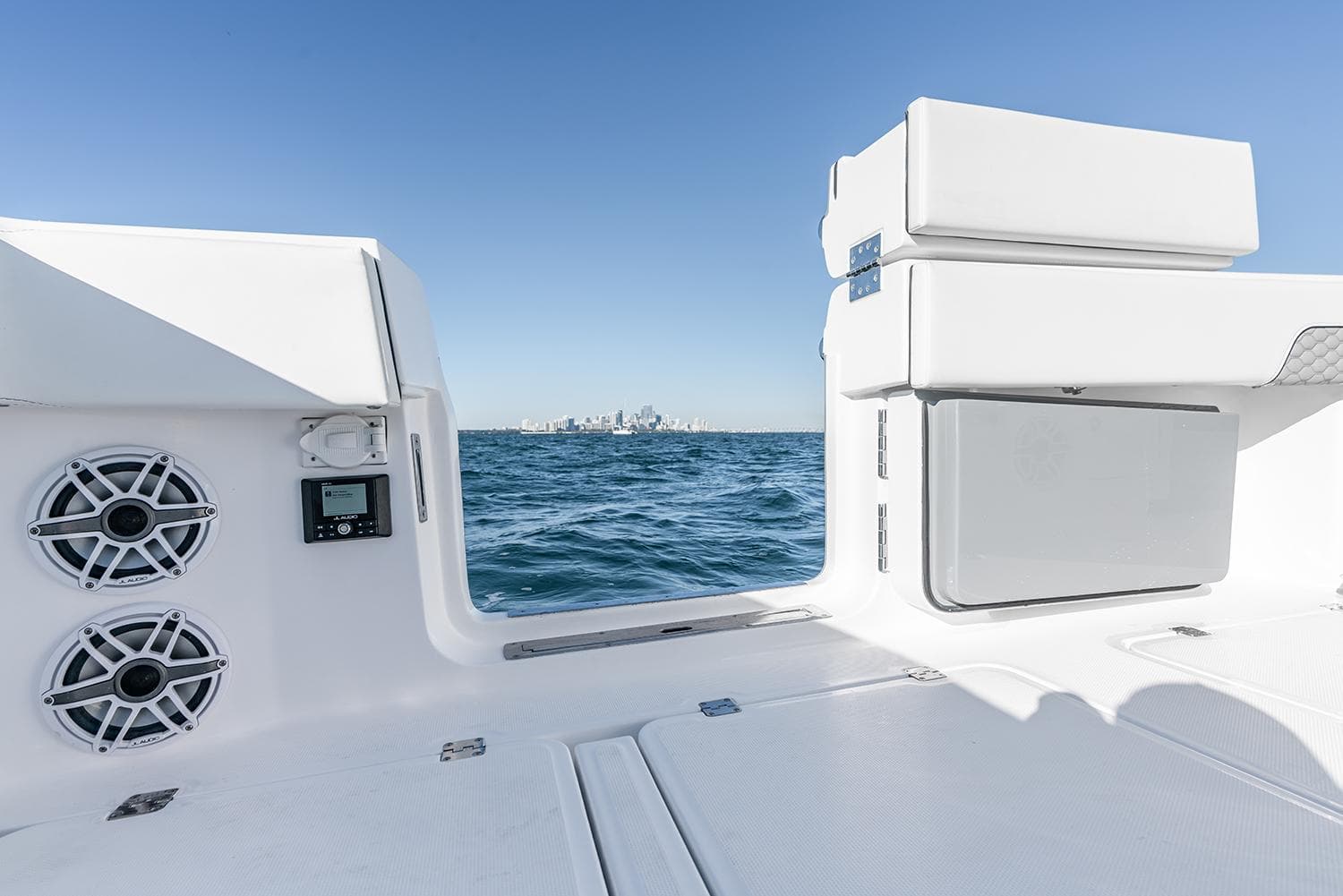 Invincible 46 Catamaran 2026 interior with ocean view, featuring speakers and storage.