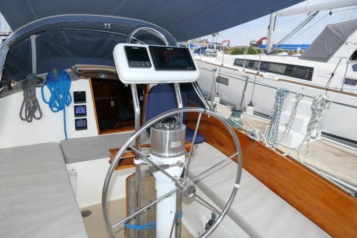 Cockpit of a 1982 Cape Dory 36 sailboat with steering wheel and navigation instruments.