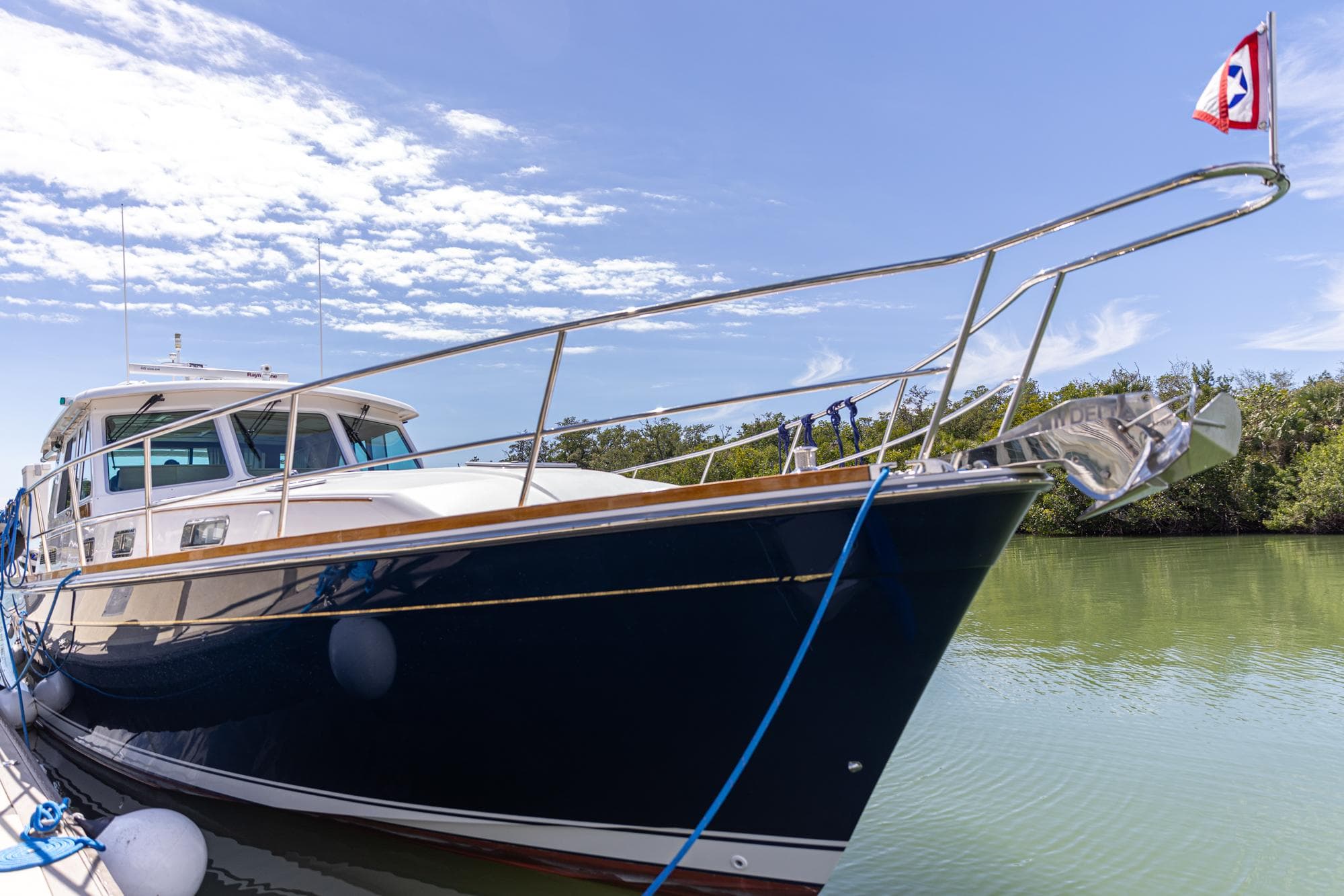 2009 Sabre 52 Express yacht docked on a sunny day, featuring sleek design and blue hull.