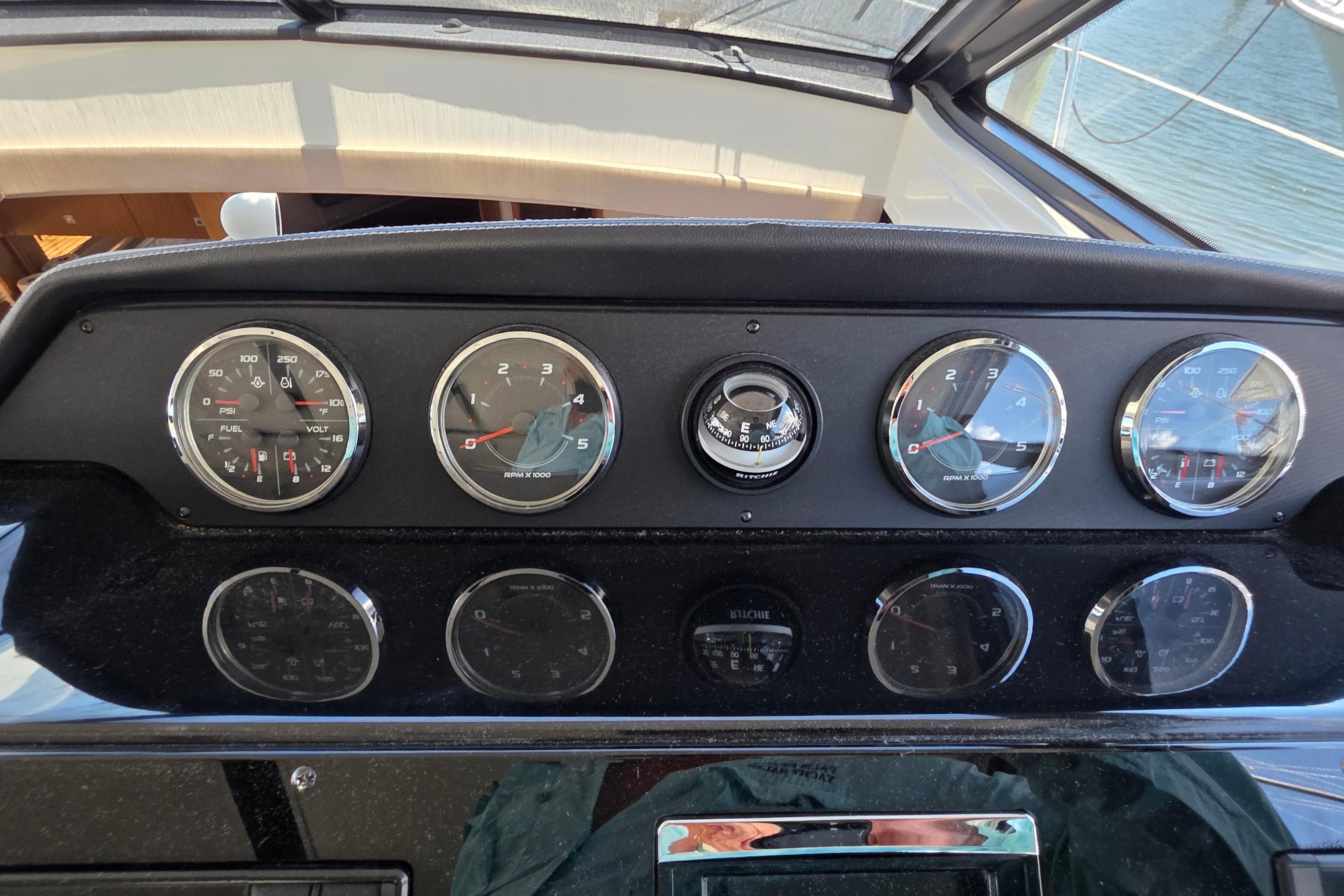 Dashboard of a 2018 Sea Ray Sundancer 510 with gauges and compass.