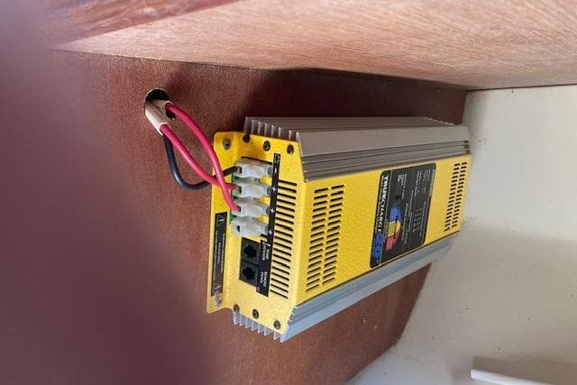 Yellow power inverter installed in a 1987 Catalina 30 MK II sailboat.