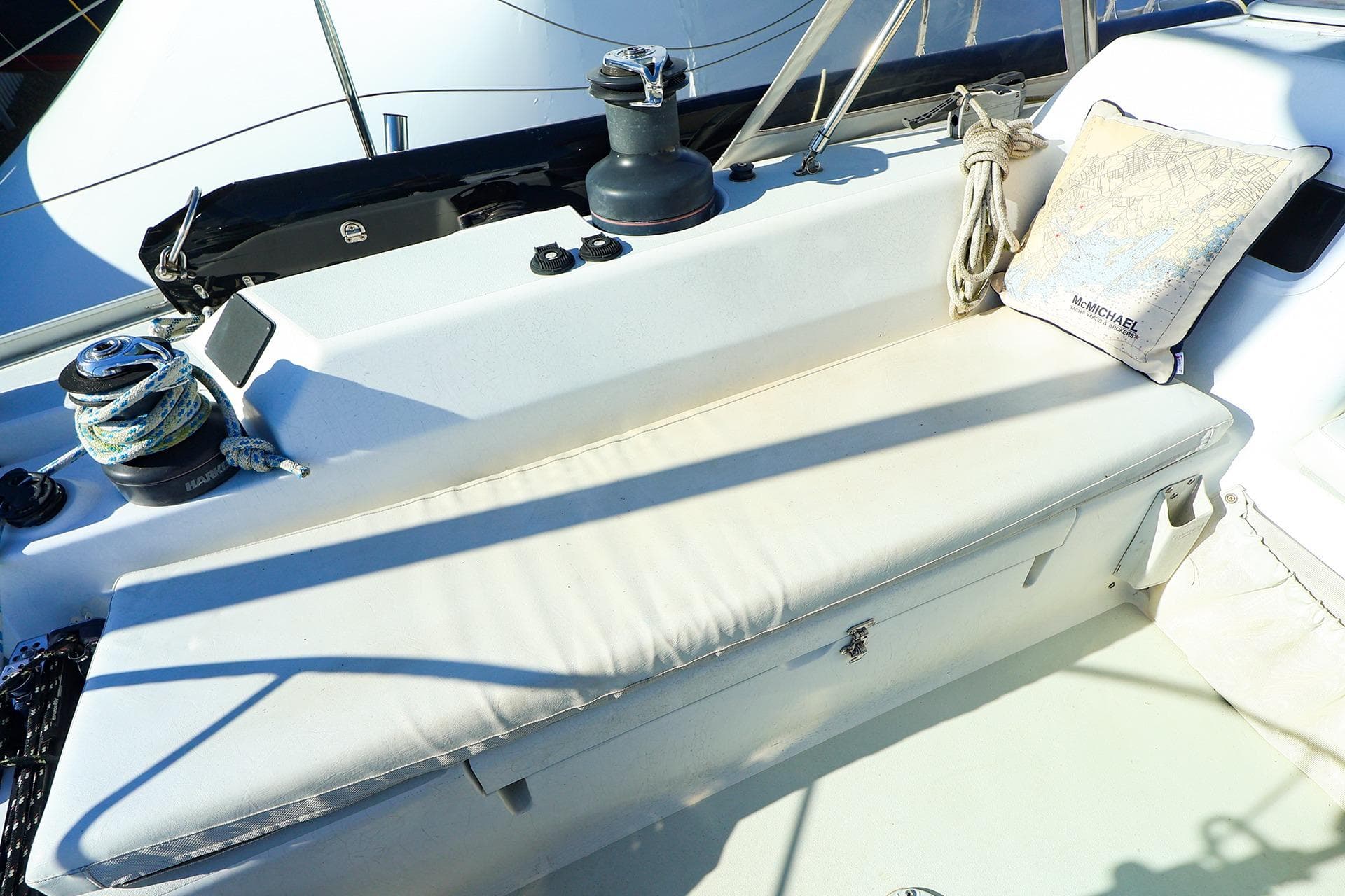 2004 J Boats J/46 sailboat cockpit with winch, ropes, and cushion.