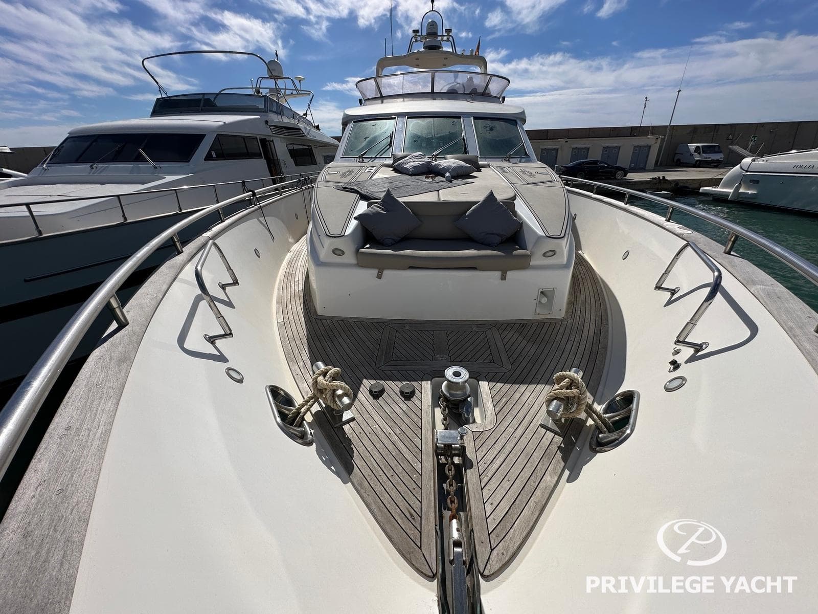 Luxurious 2003 Elegance 76 yacht docked, showcasing spacious deck and sleek design.