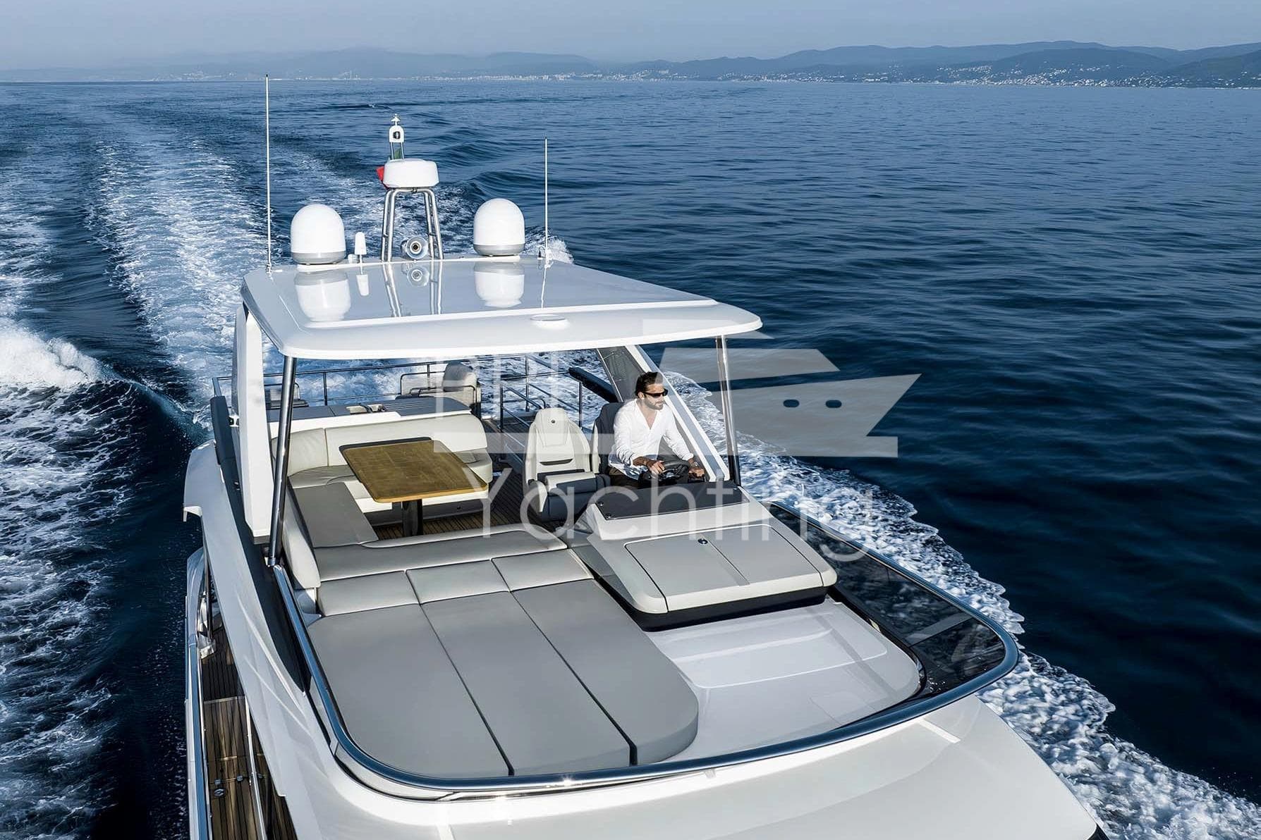 Luxurious 2026 Absolute 52 FLY yacht cruising on open sea, featuring spacious flybridge.