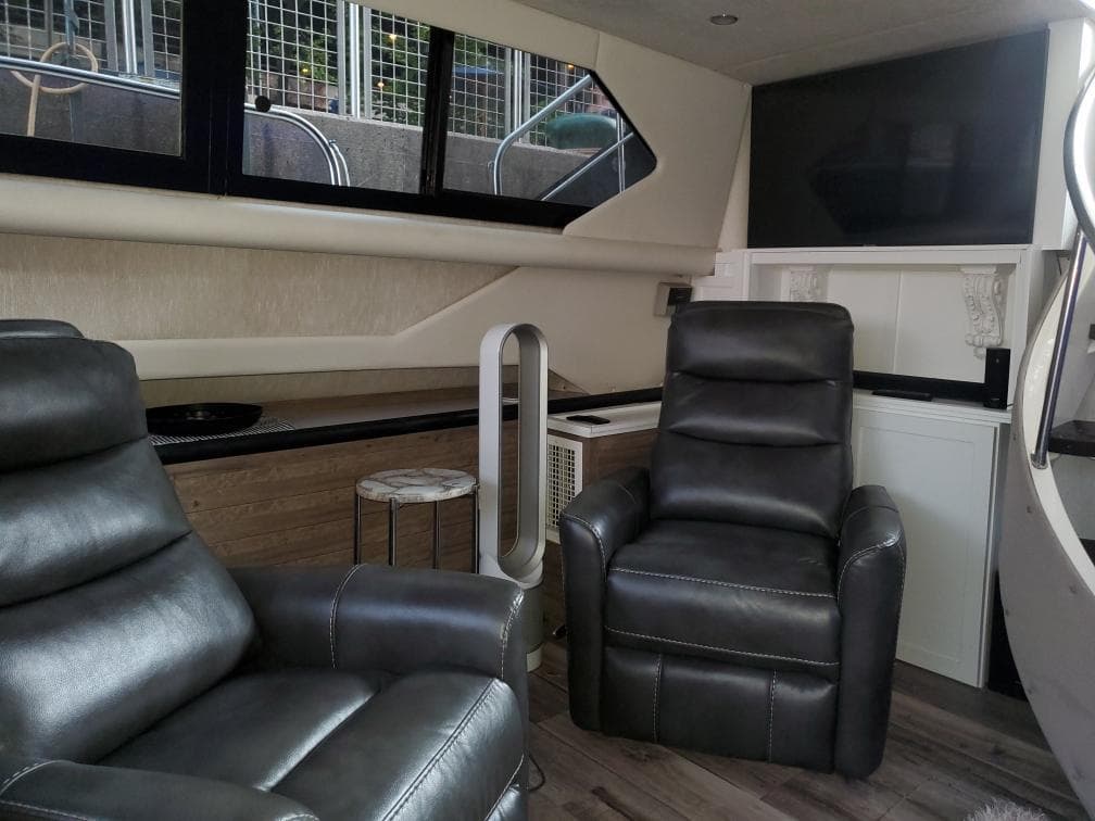 Interior of 1991 Cruisers Yachts 3850 Aft Cabin with leather chairs.