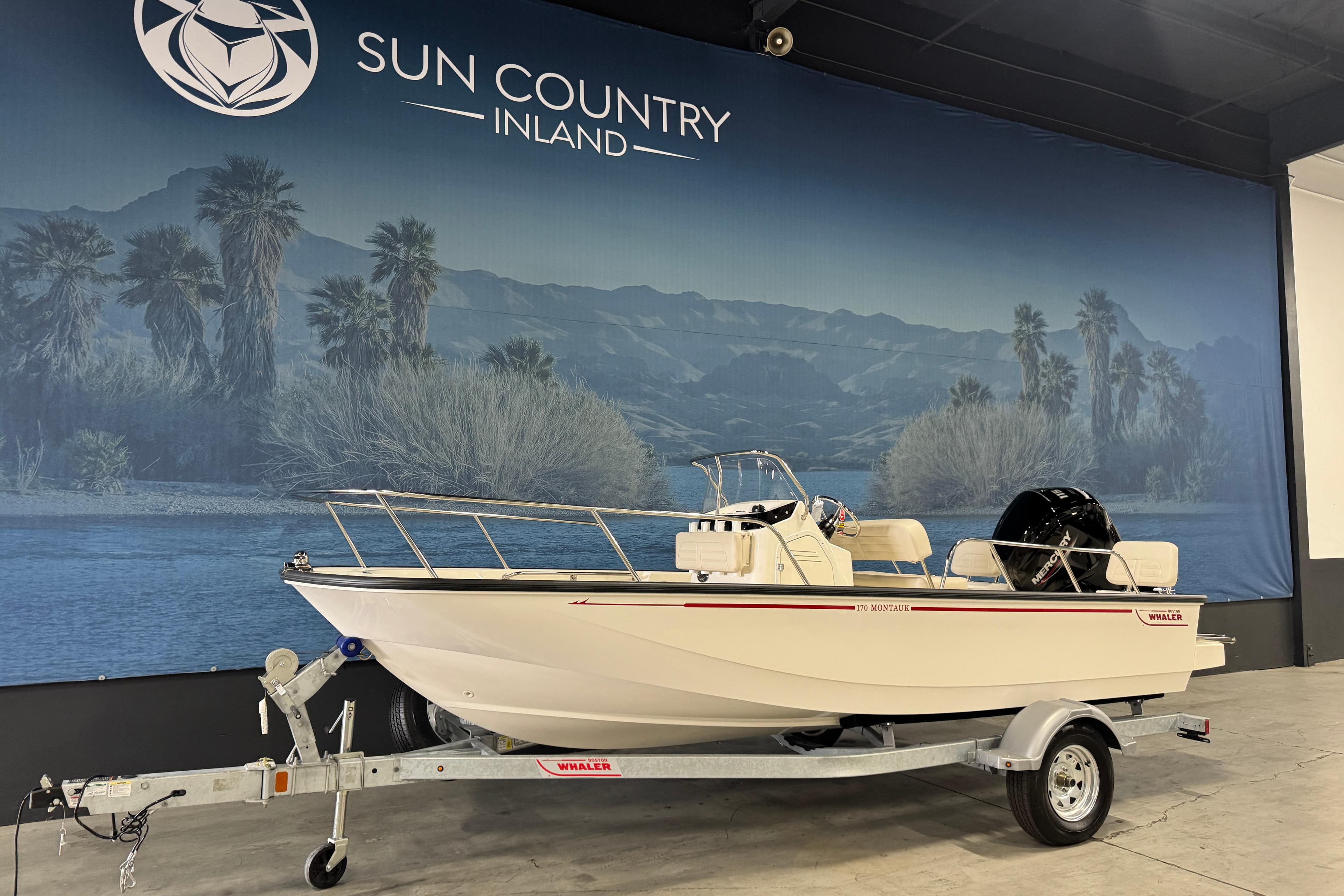 2026 Boston Whaler 170 Montauk boat on trailer at Sun Country Inland showroom.