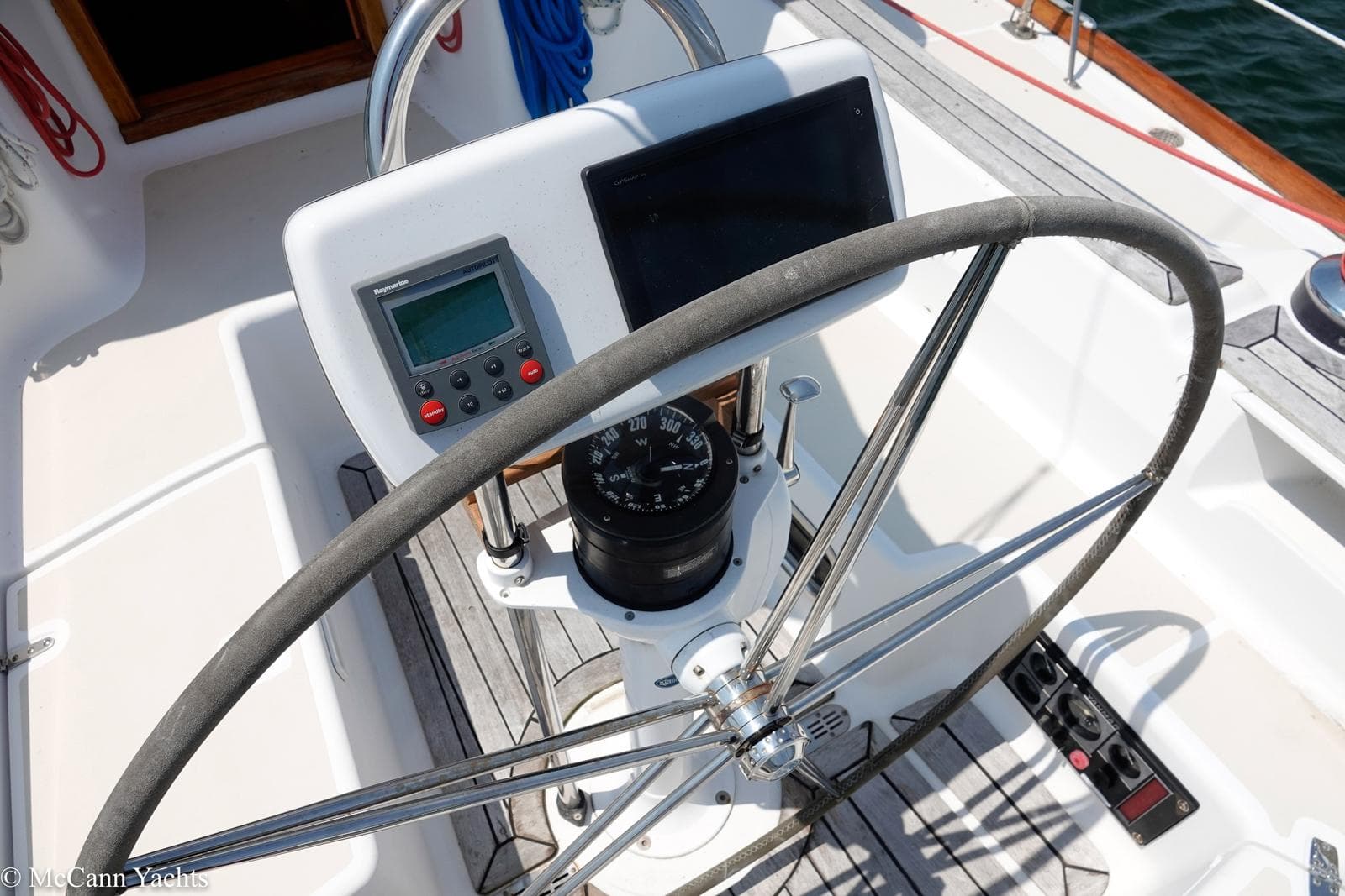 Helm of 2002 Tartan 3700 sailboat with navigation instruments and steering wheel.