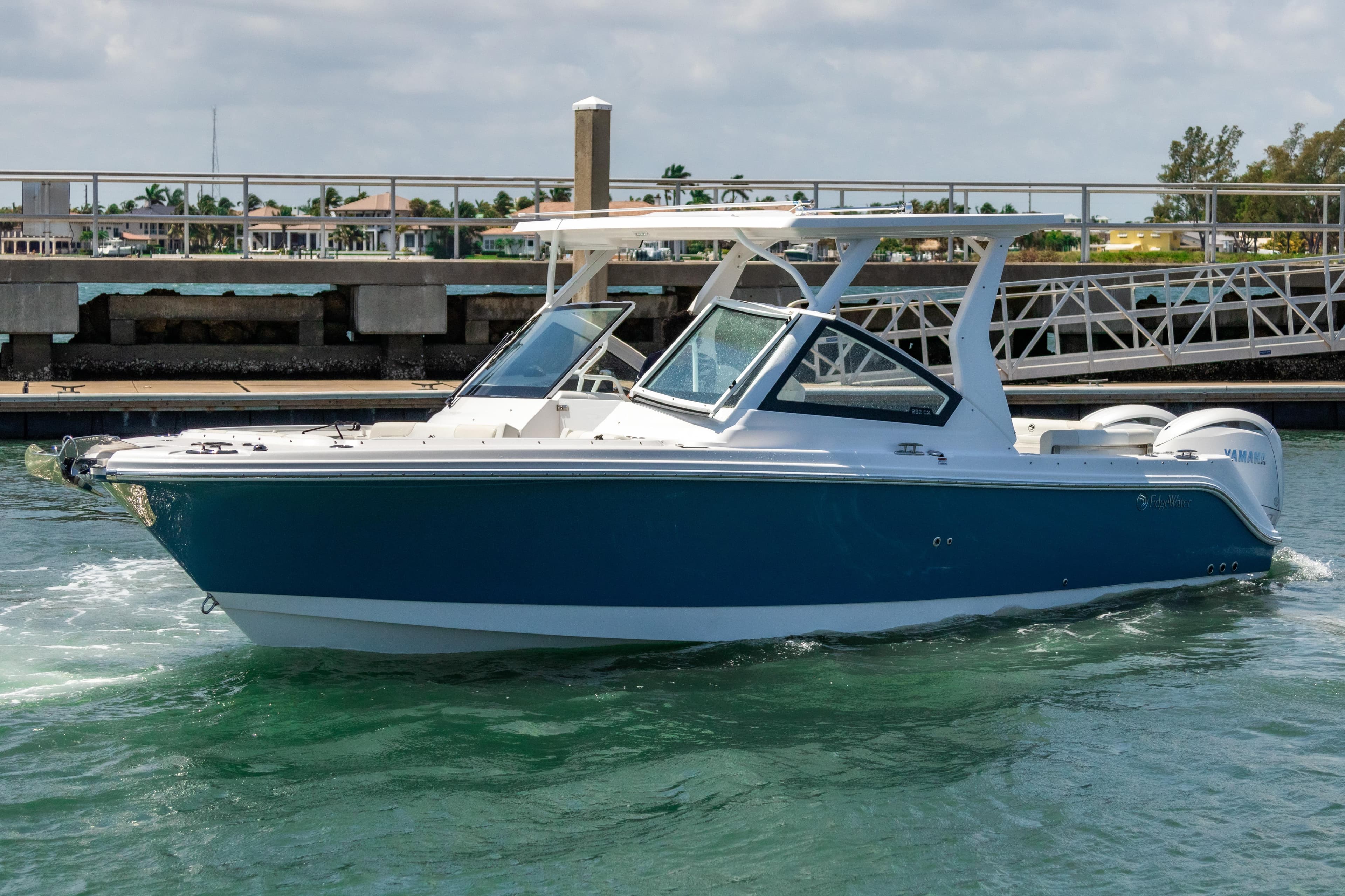 2025 Edgewater 262 CX boat cruising in a marina, featuring sleek design and modern amenities.