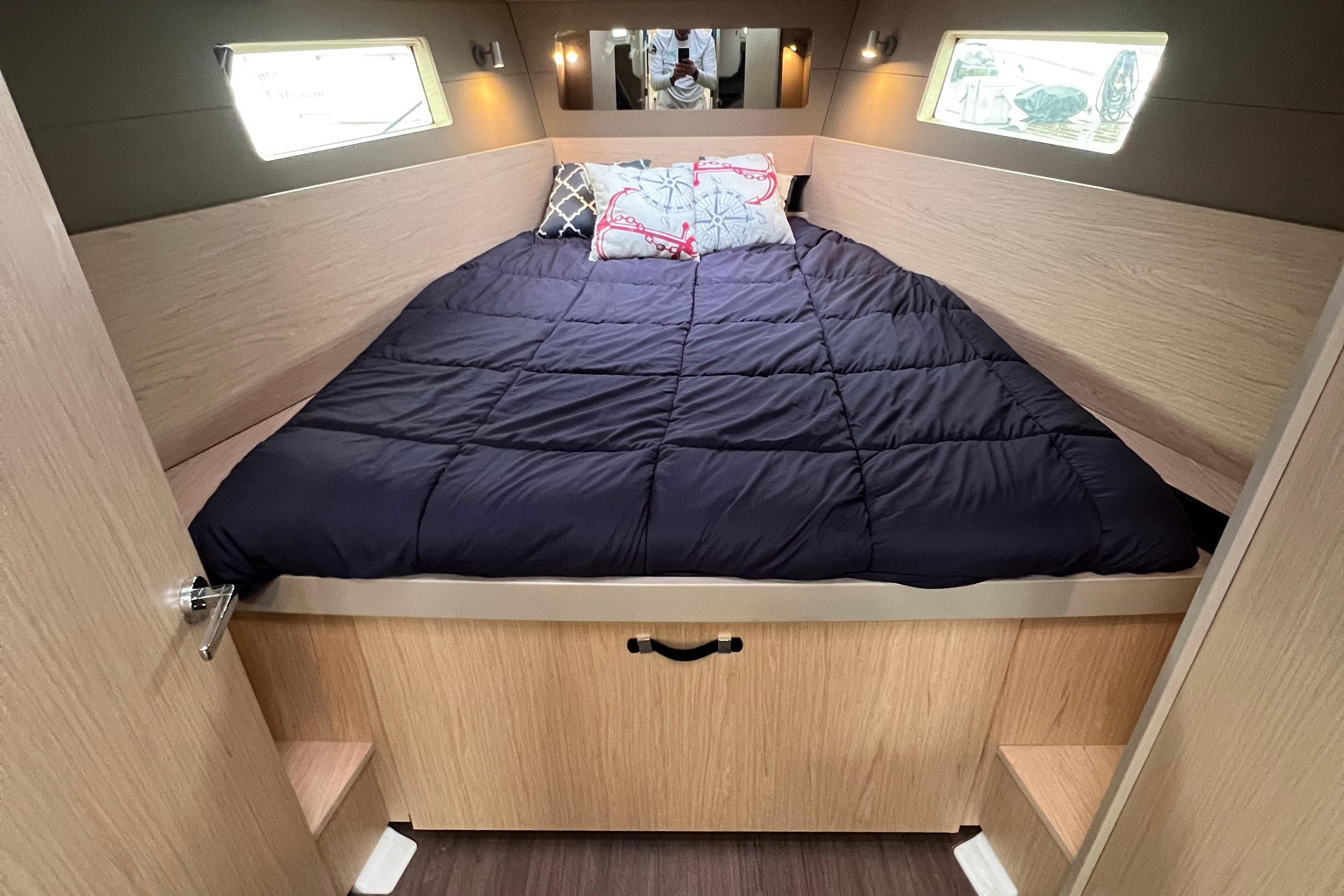 Cozy cabin interior of 2019 Beneteau Oceanis 41.1 with a comfortable bed.